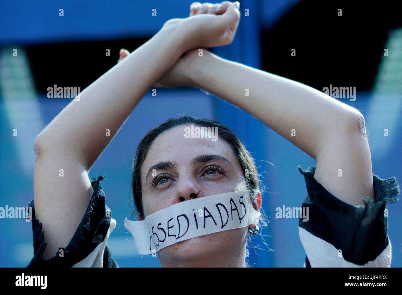 An employee of Caixa Economica Federal bank wears a sticker, reading 'Harassment', over her mouth, during a protest against the bank's president Pedro Guimaraes after allegations of sexual harassment, outside the bank's headquarters in Brasilia, Brazil June 29, 2022. REUTERS/Ueslei Marcelino Stock Photo