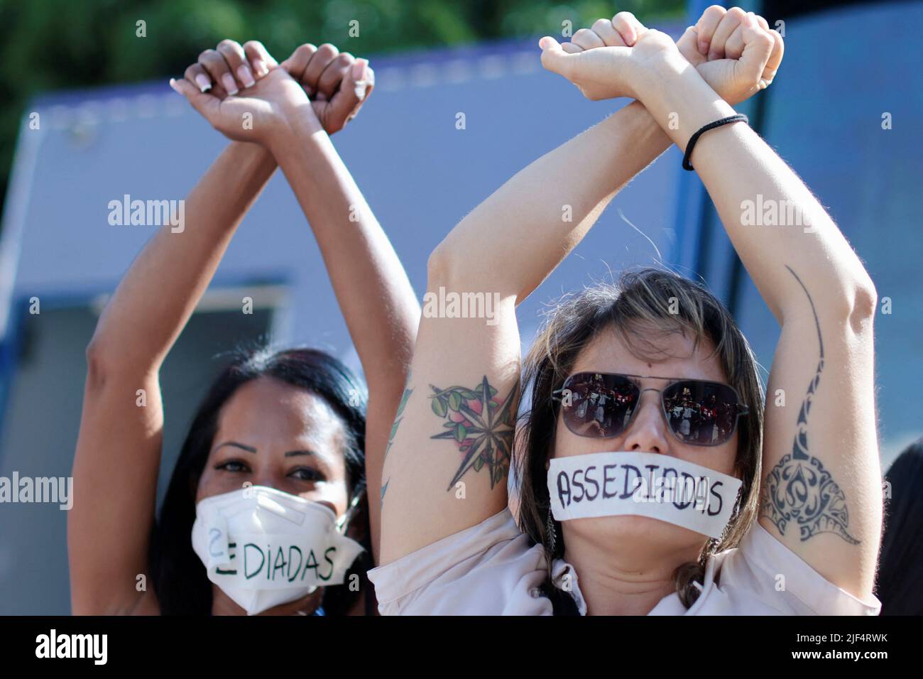 Employees of Caixa Economica Federal bank wear stickers over their mouths, reading 'Harassment', during a protest against the bank's president Pedro Guimaraes after allegations of sexual harassment, outside the bank's headquarters in Brasilia, Brazil June 29, 2022. REUTERS/Ueslei Marcelino Stock Photo