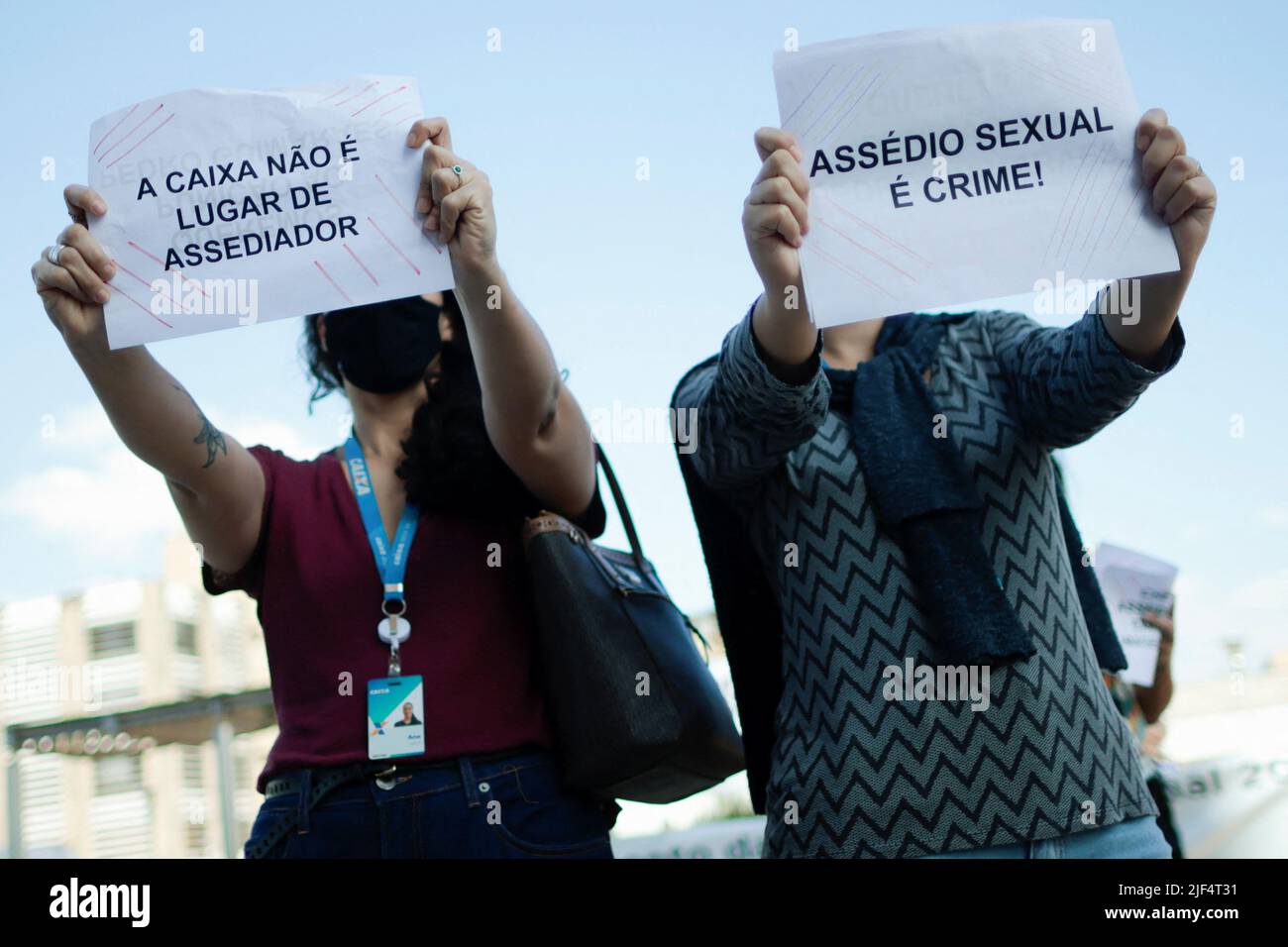 Employees of Caixa Economica Federal bank take part in a protest against the bank's president Pedro Guimaraes after allegations of sexual harassment, outside the bank's headquarters in Brasilia, Brazil June 29, 2022. REUTERS/Ueslei Marcelino Stock Photo