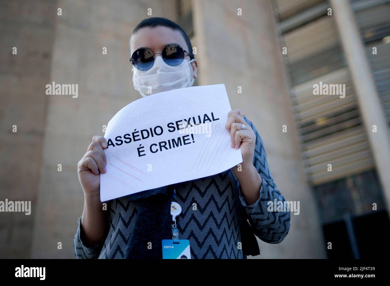 A employee of Caixa Economica Federal bank takes part in a protest against the bank's president Pedro Guimaraes after allegations of sexual harassment, outside the bank's headquarters in Brasilia, Brazil June 29, 2022. REUTERS/Ueslei Marcelino Stock Photo