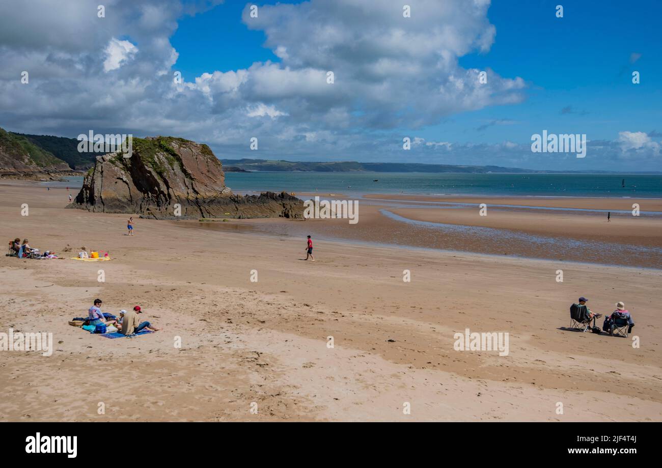 sand,sun bathers,sun seekers,swimmers,bathers,island on beach,island in sea,blue sky,waves,seaside,sea,Pembrokeshire,Pembroke,Wales,beach,Tenby North Stock Photo