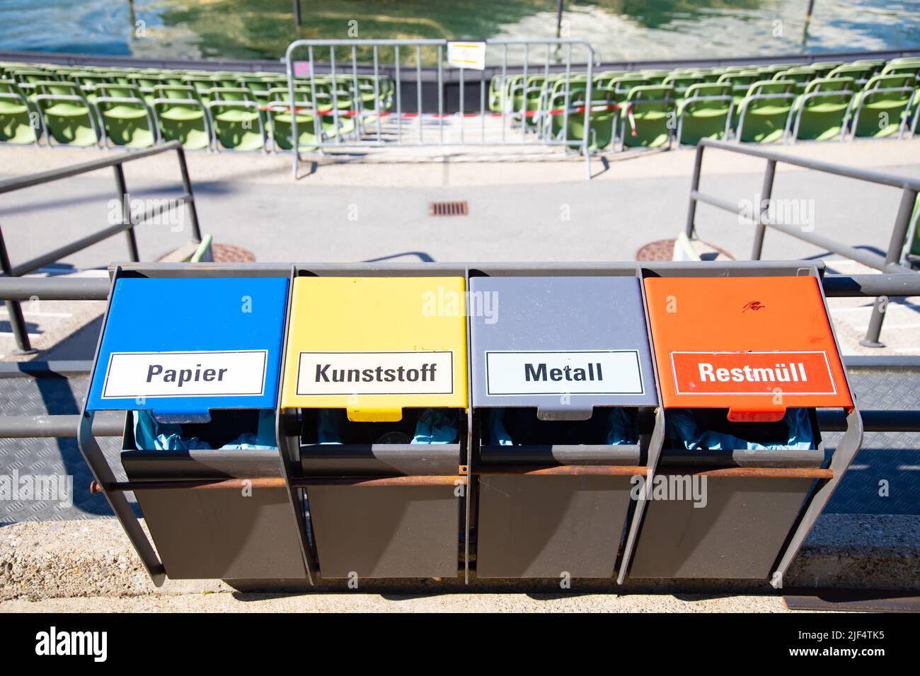 Metal containers for different garbage with an inscription in german at