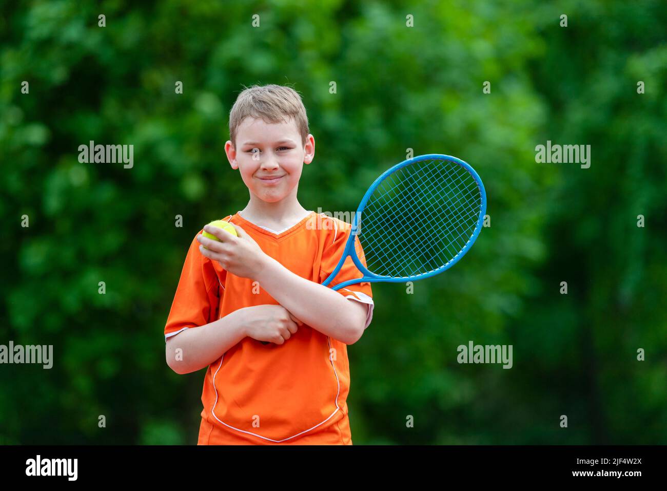Child with tennis racket on tennis court. Training for young kid ...