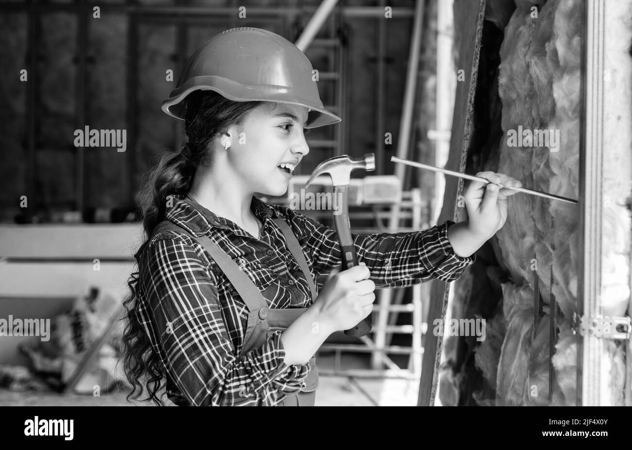 happy kid engineer with hammer tool in hard hat, engineering Stock