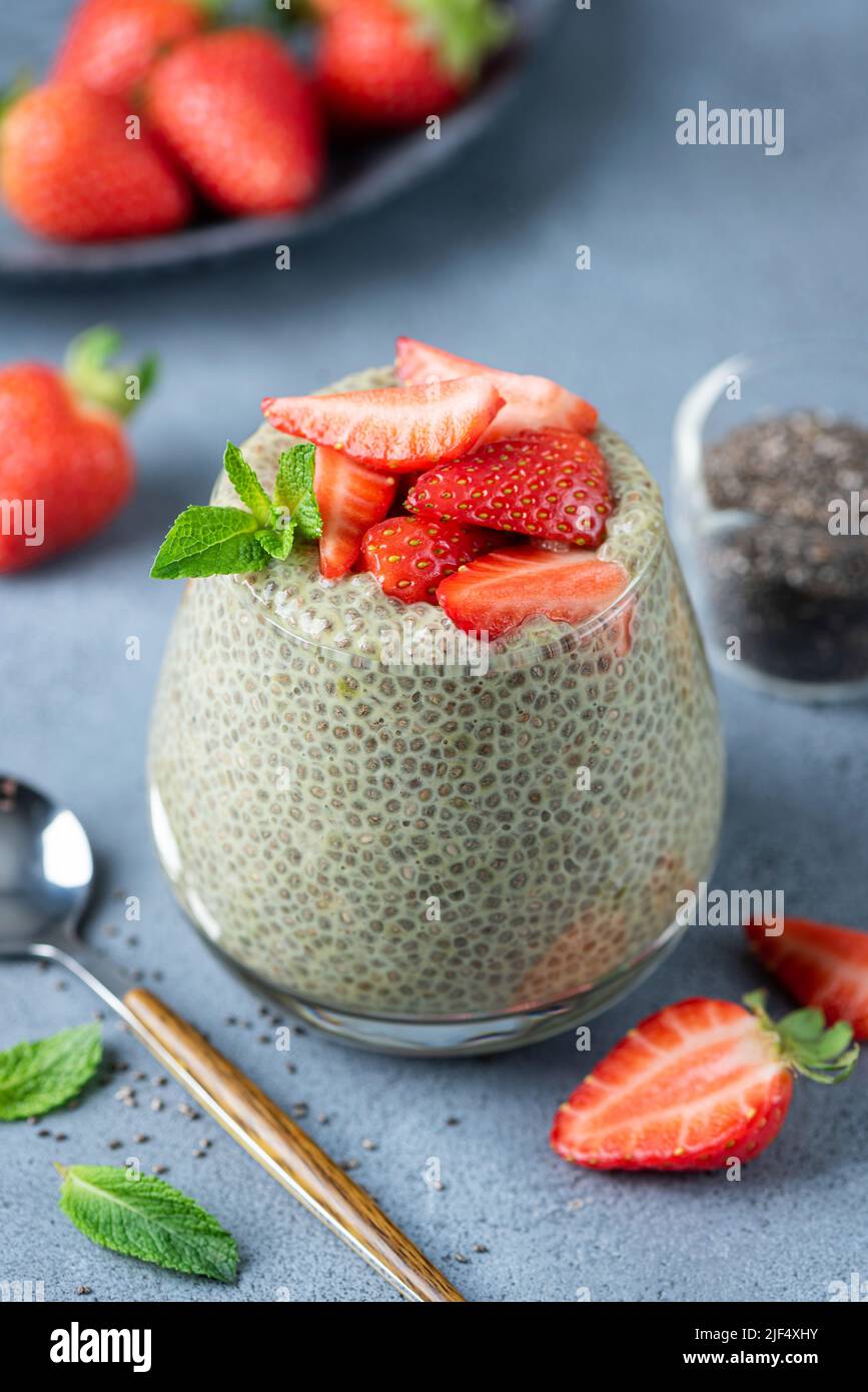 Vegan Chia Seed Pudding With Green Tea Matcha And Strawberries In Glass. Closeup View. Healthy Dessert For Breakfast Stock Photo