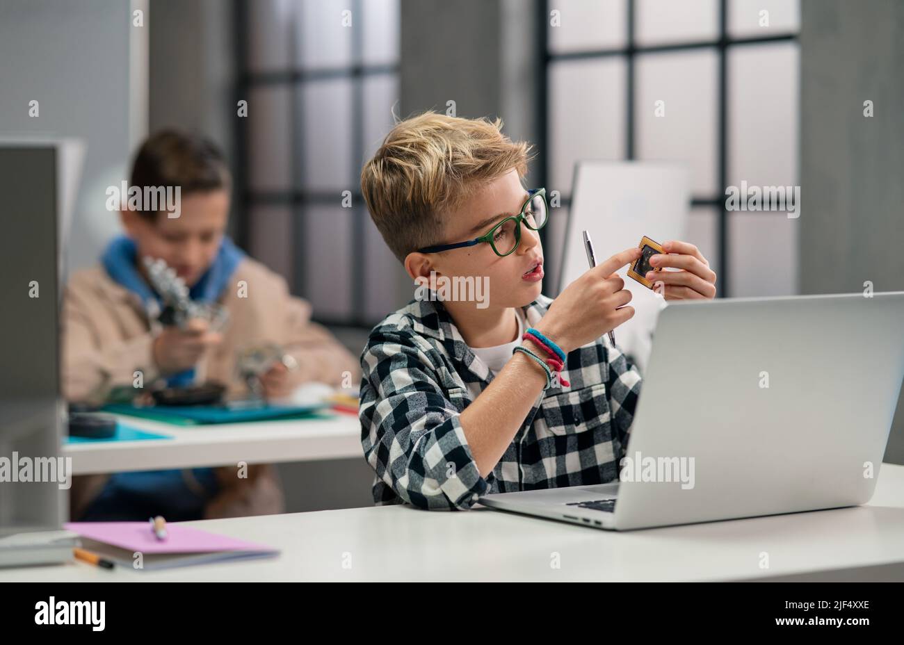 Pupils at school working with electronics component at robotics classroom. Stock Photo