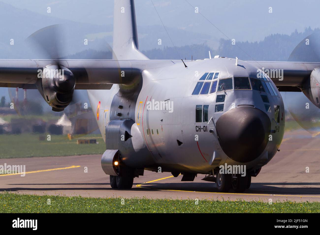 A Spanish Air Force Hercules military transport aircraft taxiing at airbase Zeltweg in Austria to the runway with turning propellers Stock Photo