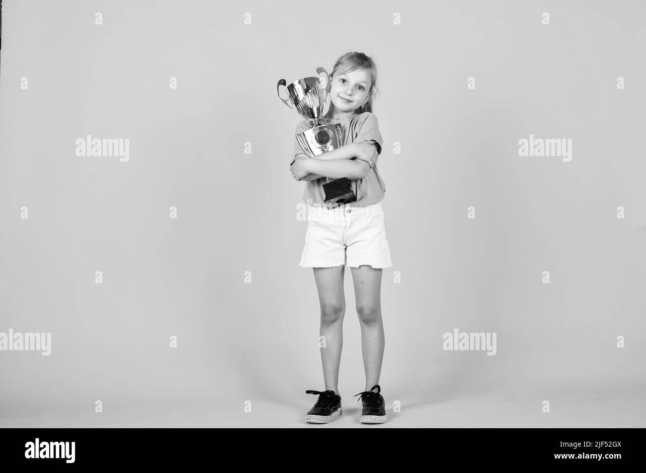 cute kid hold champion cup, sport success Stock Photo