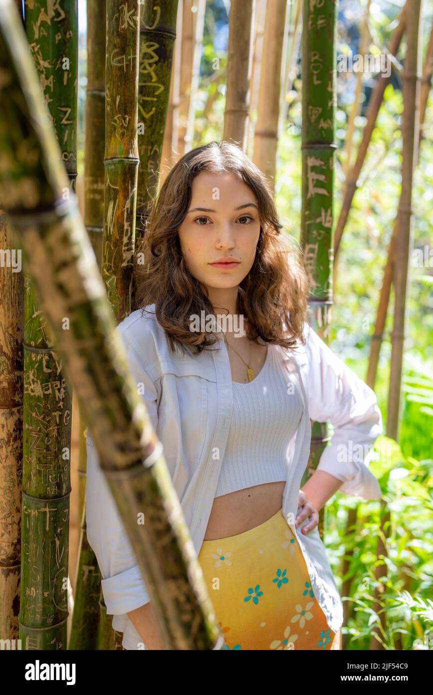 Portrait of Young Woman Standing in a Bamboo Forest | Garden | Dappled Sunlight Stock Photo