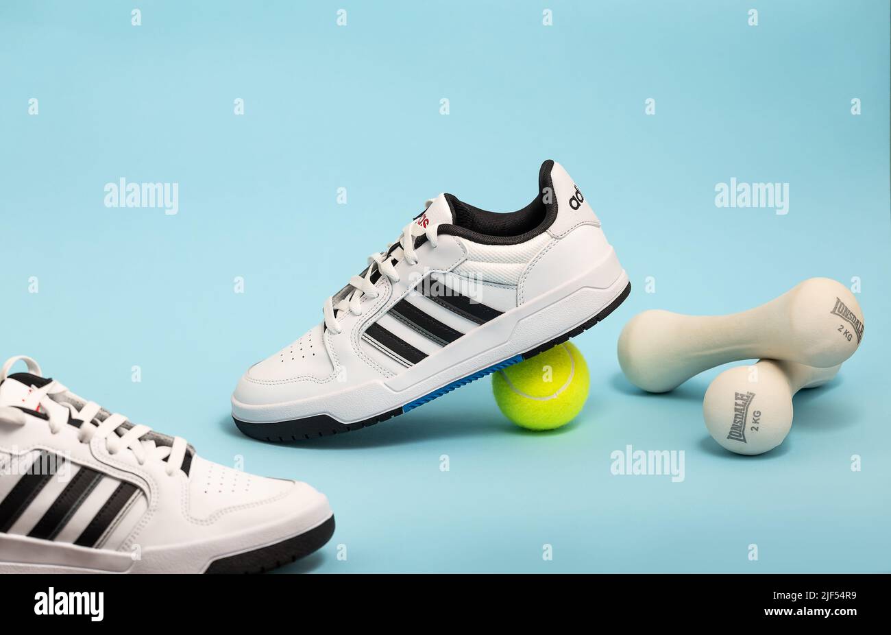 Belgrade, Serbia - May 11, 2022. New Adidas tennis shoes on blue background  with tennis balls. New Adidas Sneakers or trainers on blue background. Men  Stock Photo - Alamy