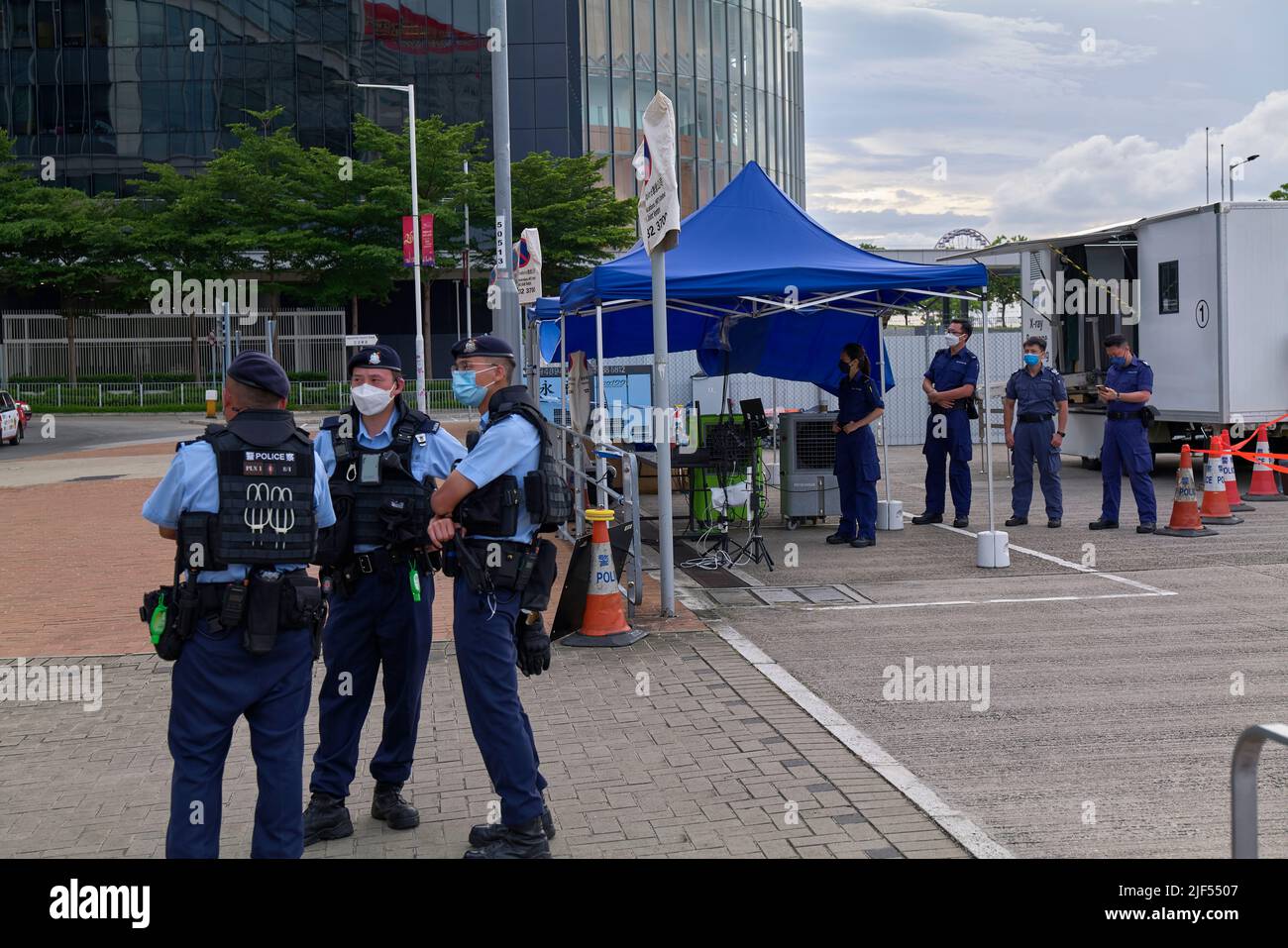 Police and mine clearance officers wait outside an xray baggage