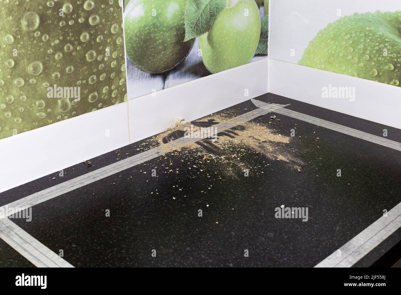 Installation of a kitchen countertop sink and faucet. The black