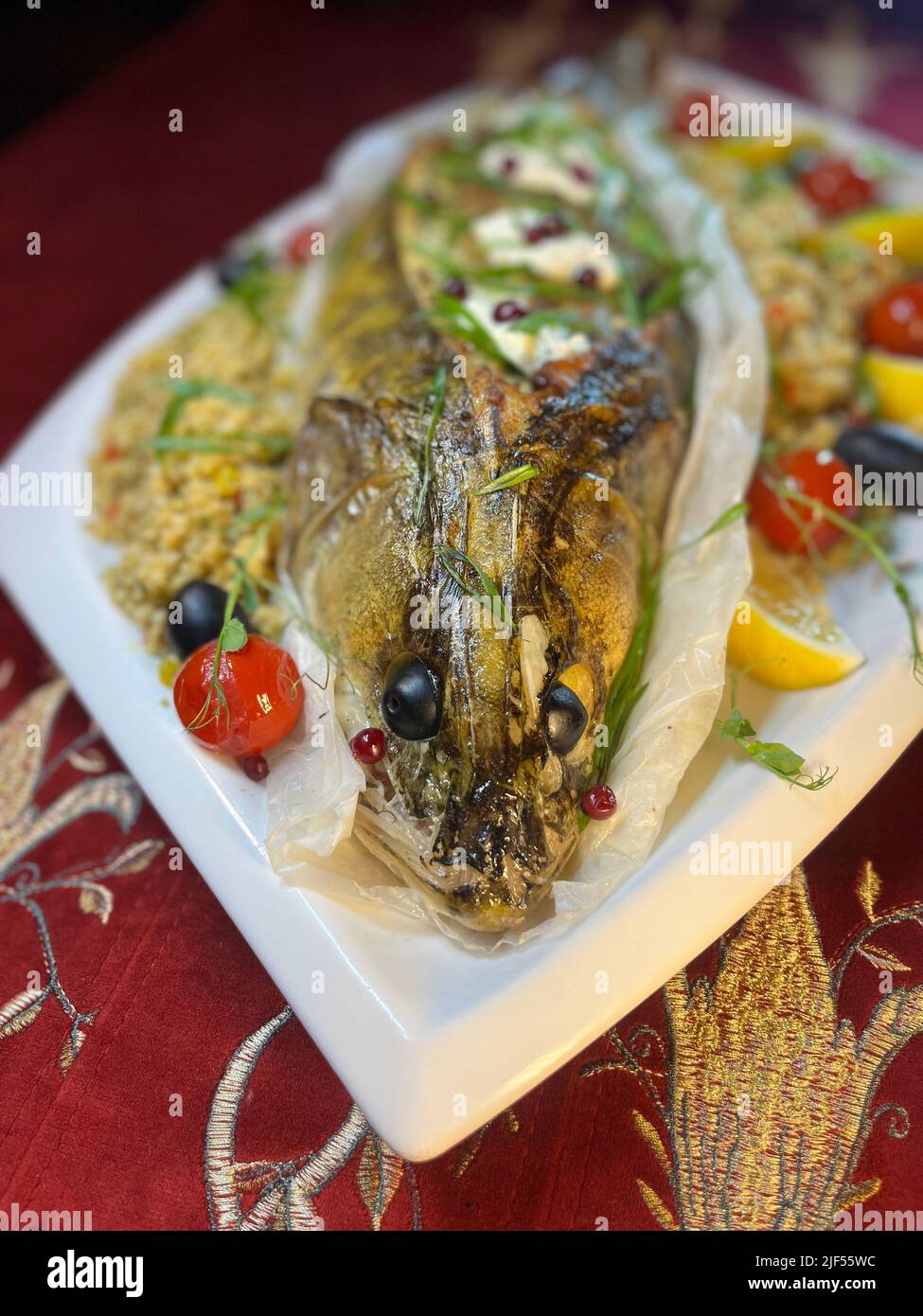 Baked stuffed pike perch with a side dish. fish dish in a restaurant