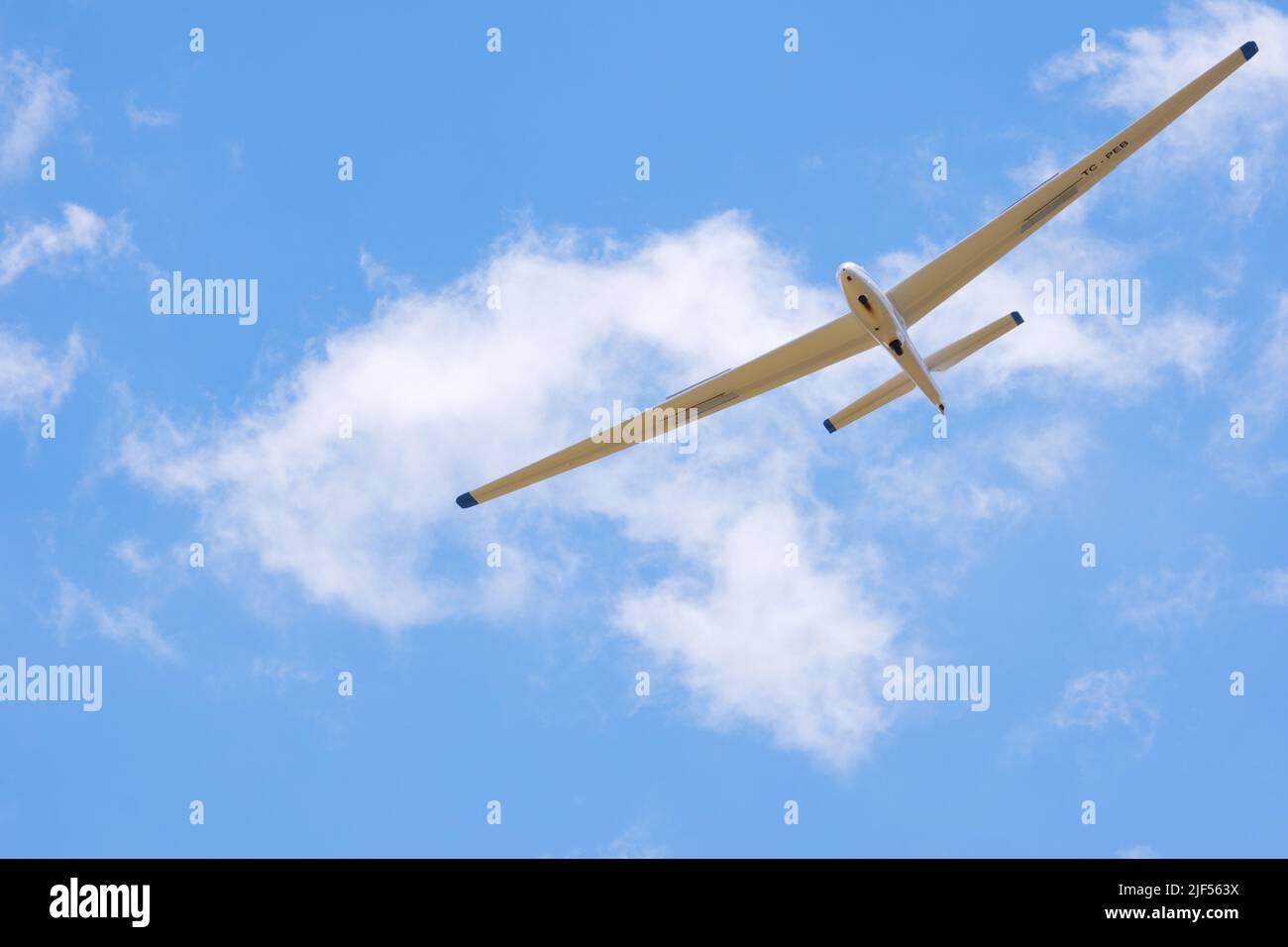 Glider flying high at blue sky with light clouds Stock Photo Alamy
