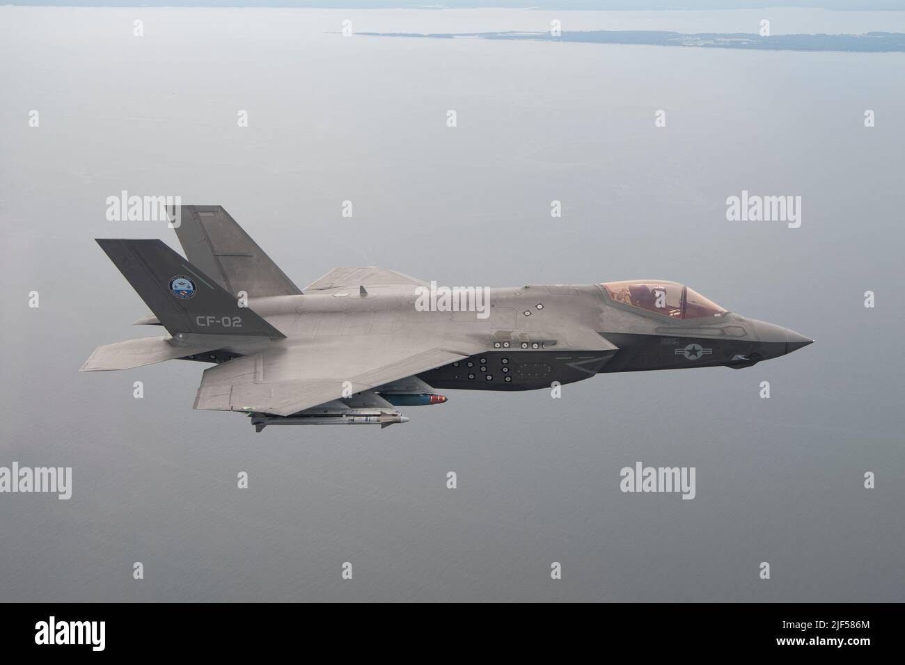 U.S. Marine Corps test pilot Maj. Dylan “Bilbo” Nicholas pilots an F-35C during a GBU-38/54 flight test at NAS Patuxent River, Maryland, on June 21, 2022. Before new weapons and aircraft capabilities are integrated into operational fleet squadrons the Pax River F-35 Integrated Test Force and Air Test and Evaluation Squadron (VX) 23 developmental test pilots thoroughly test them. The F-35, which has been operational since 2015, is the most lethal, survivable, and interoperable fighter aircraft ever built. Stock Photo