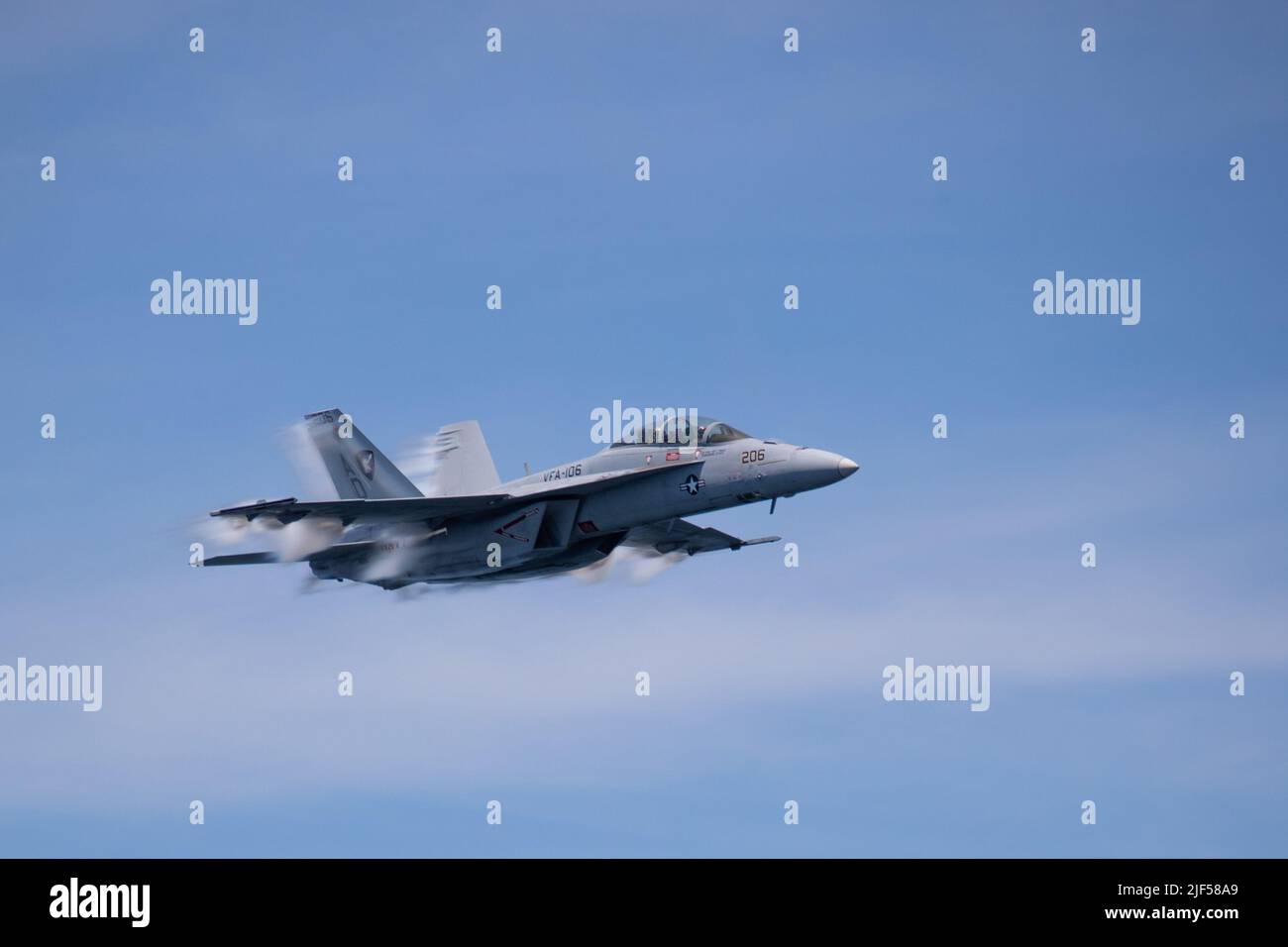 An F/A-18F Super Hornet, attached to the “Blacklions” of Strike Fighter Squadron (VFA) 213 conducts a fly by during USS Gerald R. Ford’s (CVN 78) friends and family day cruise, June 25, 2022. Friends and family members were invited aboard Ford to experience a day in the life of a Sailor at sea first-hand. (U.S. Navy photo by Mass Communications Specialist 2nd Class Jackson Adkins) Stock Photo