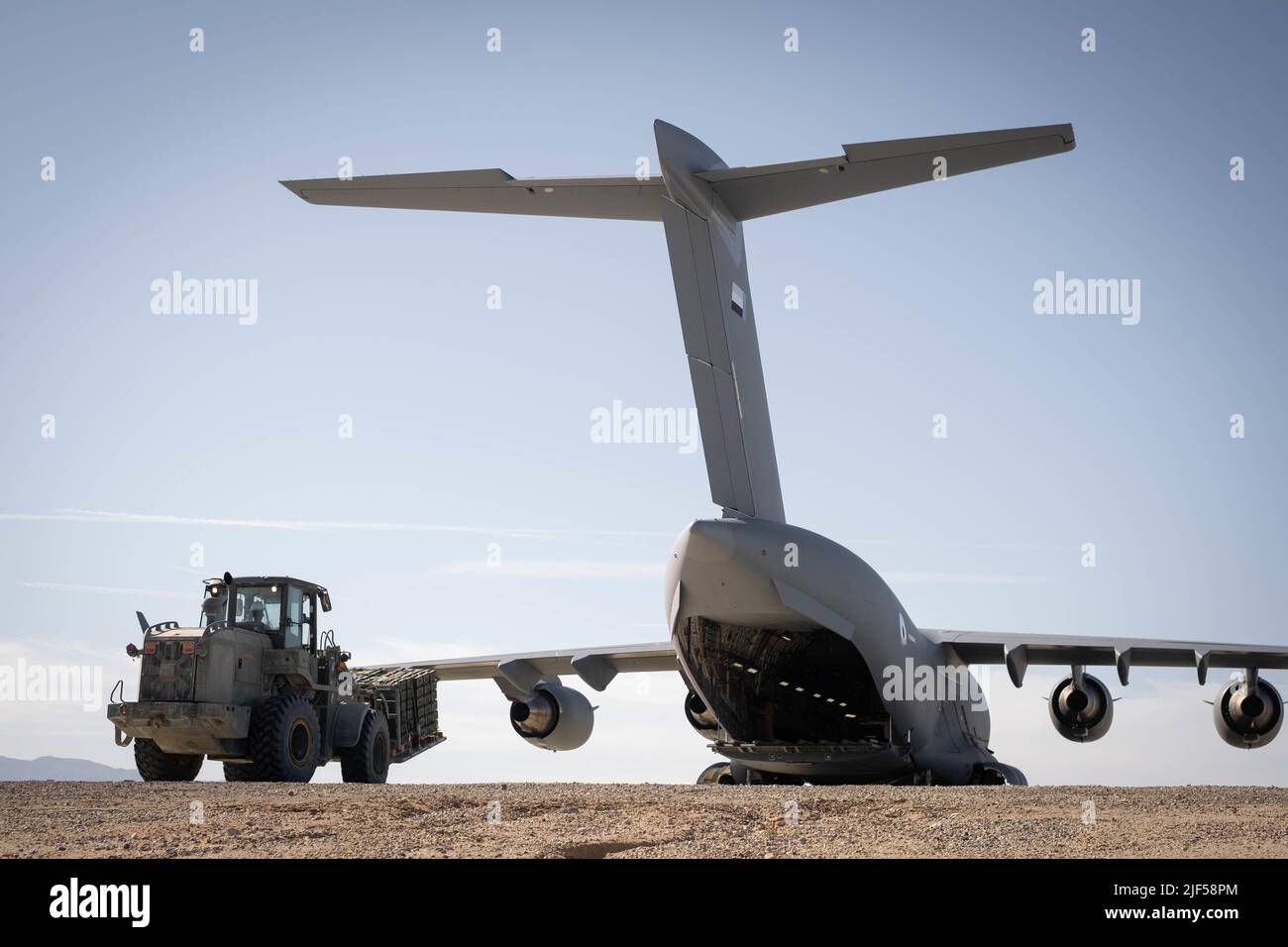 A U.S. Marine Corps TX51-19MD forklift loads a pallet of ammunition into a C-17 Globemaster aircraft, 16th Strategic Airlift Squadron, United Arab Emirates Air Force, at the Strategic Expeditionary Landing Field during an ammunition retrograde on Marine Corps Air Ground Combat Center, Twentynine Palms, California, Feb. 25, 2022. The U.S. Marine Corps and UAE maintain a close relationship through persistent bilateral training engagements and programs, enhancing each other’s ability to conduct counterterrorism operations, protect critical infrastructure, and support national defense.  (U.S. Mari Stock Photo