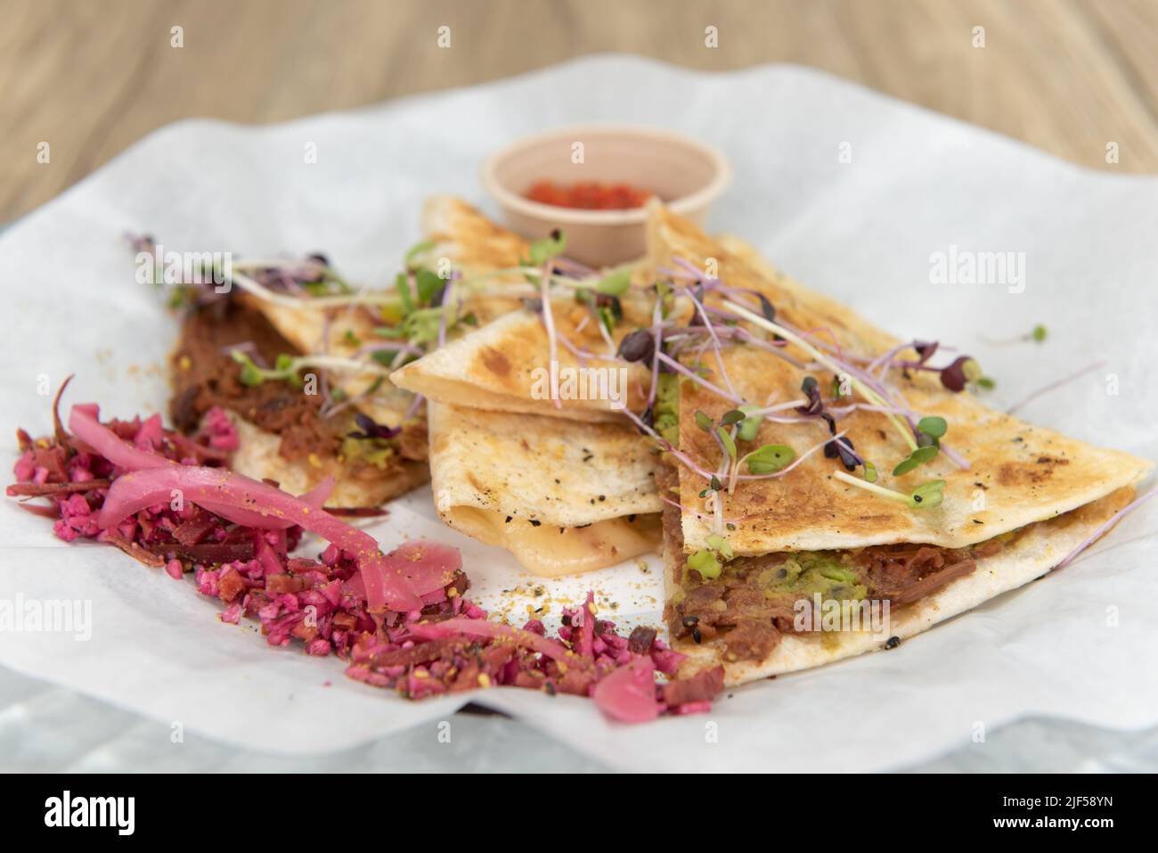 Nutritious cheese quesadilla with BBQ jerk jackfruit on a tortilla will