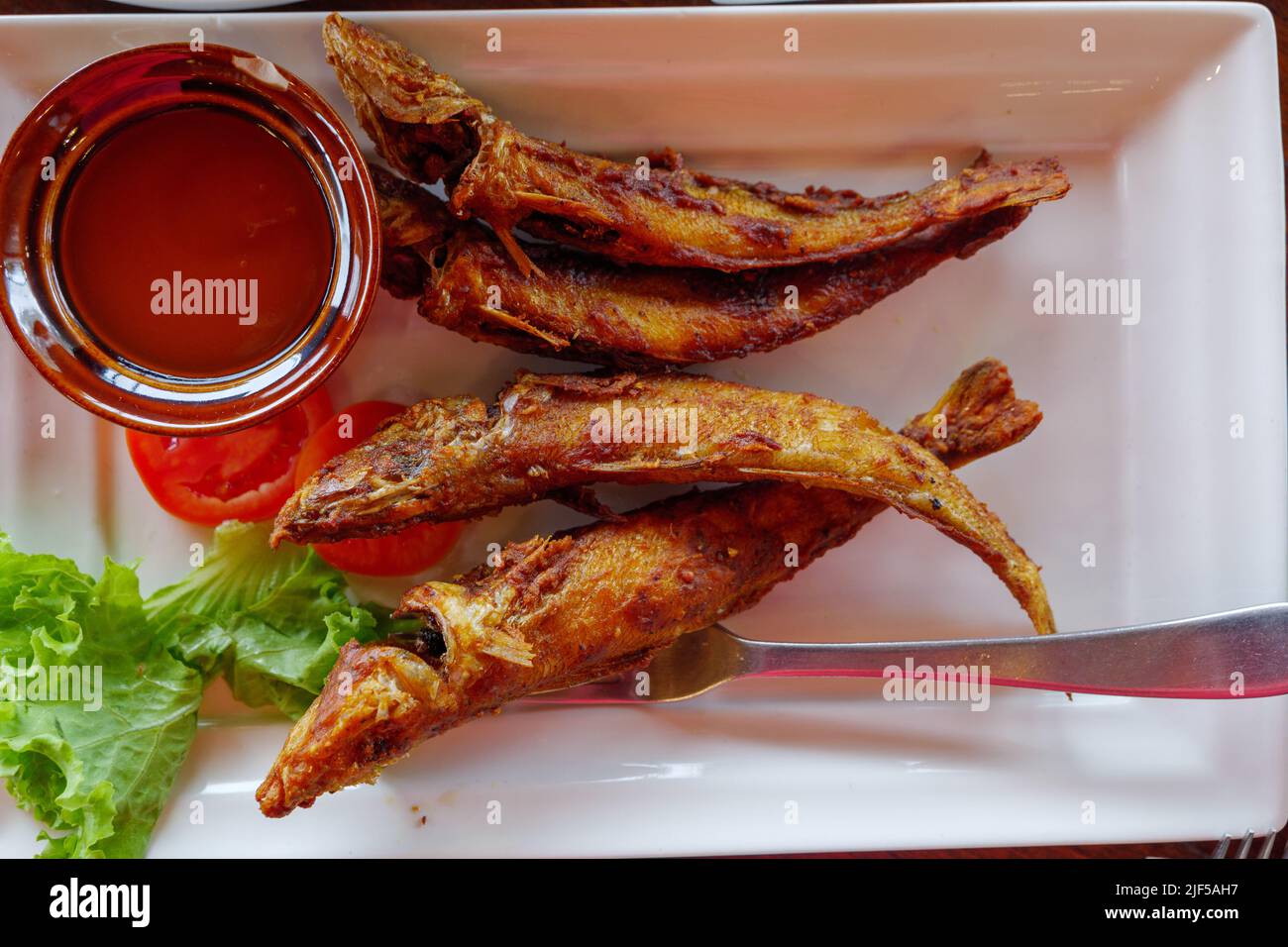Fried Whiting Fish with Garlic and Turmeric and chilli fish sauce on