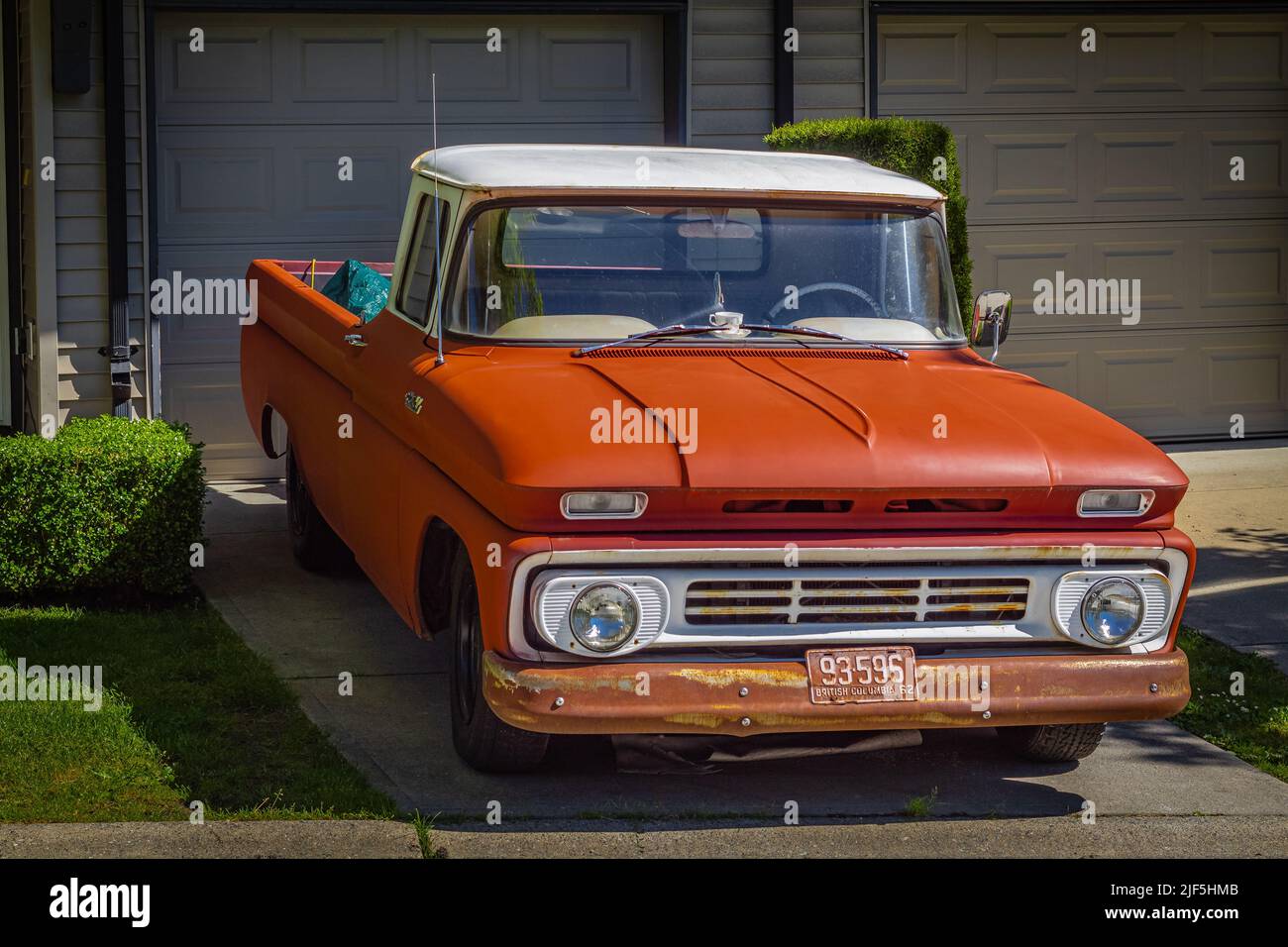 Retro pickup truck on a sunny summer day. Orange Chevrolet C10 Pick Up Truck. Vintage Chevy truck parked on a street-Vancouver BC Canada-June 24,2022. Stock Photo
