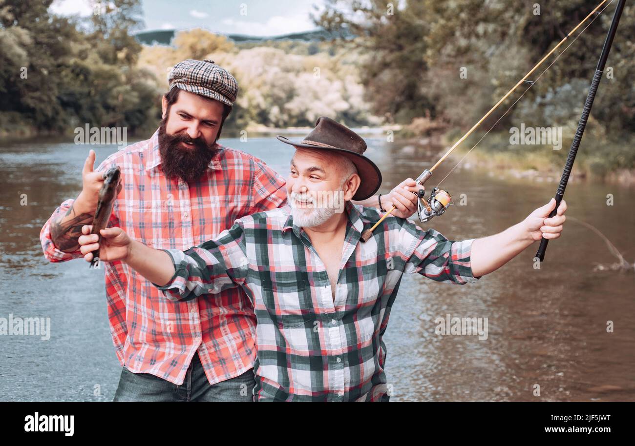 Fishing in river. Portrait of cheerful two bearded men fishing
