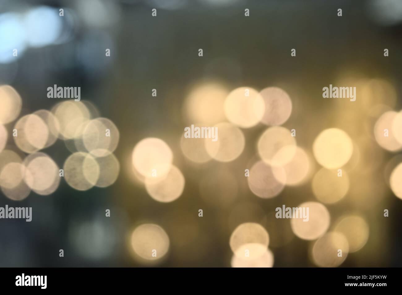 Bokeh from indoor lighting,  Colorful light circles spread on blue with yellow and green background for the celebration of the holiday season Stock Photo