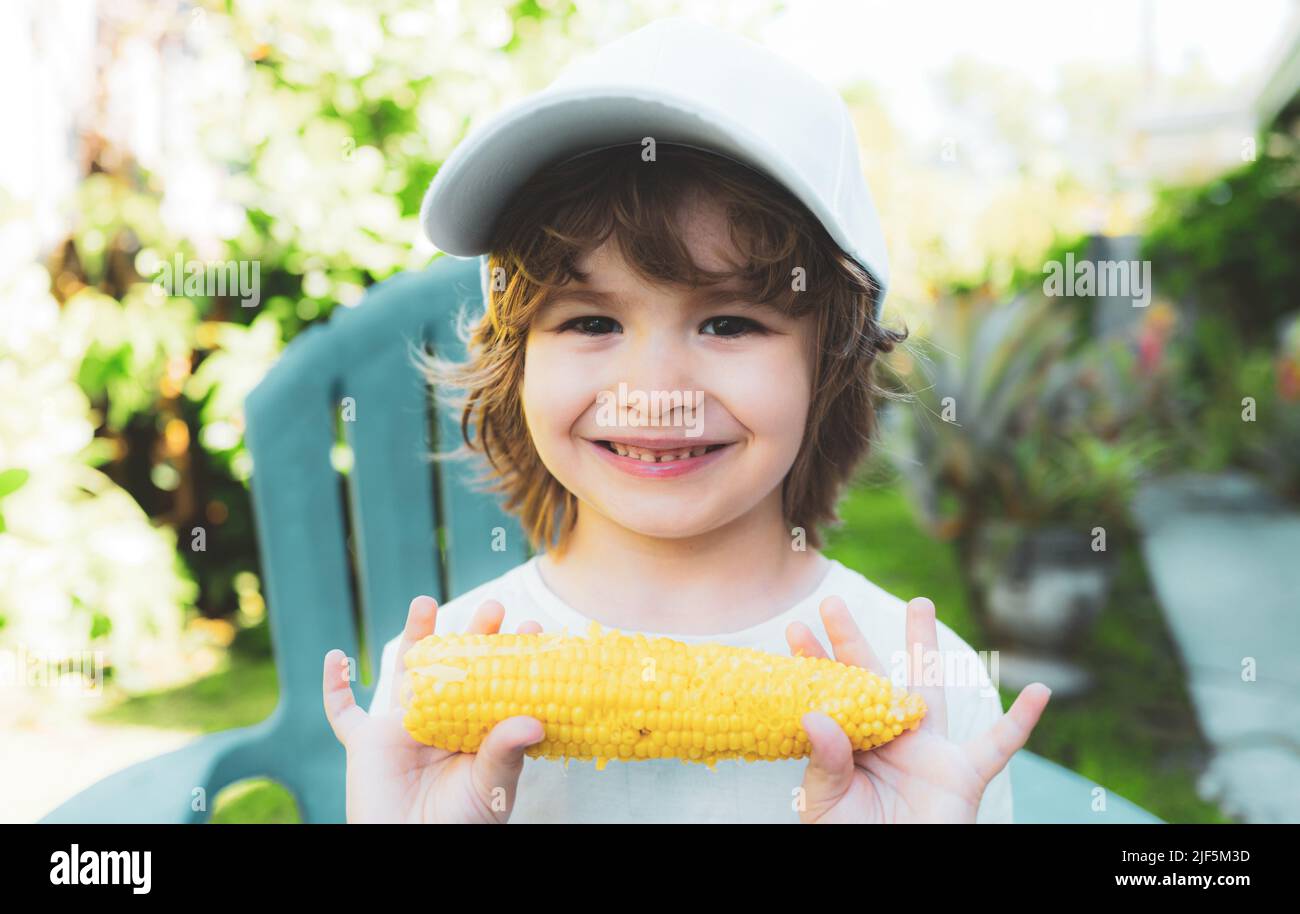 Happy Little boy eating corn on the cob. Food for kids Stock Photo Alamy