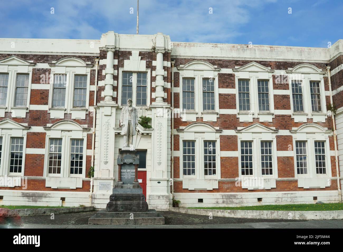 Hokitika New Zealand -May 5 2022; Old brick government, Seddon House, with statue Richard John Seddon. Stock Photo