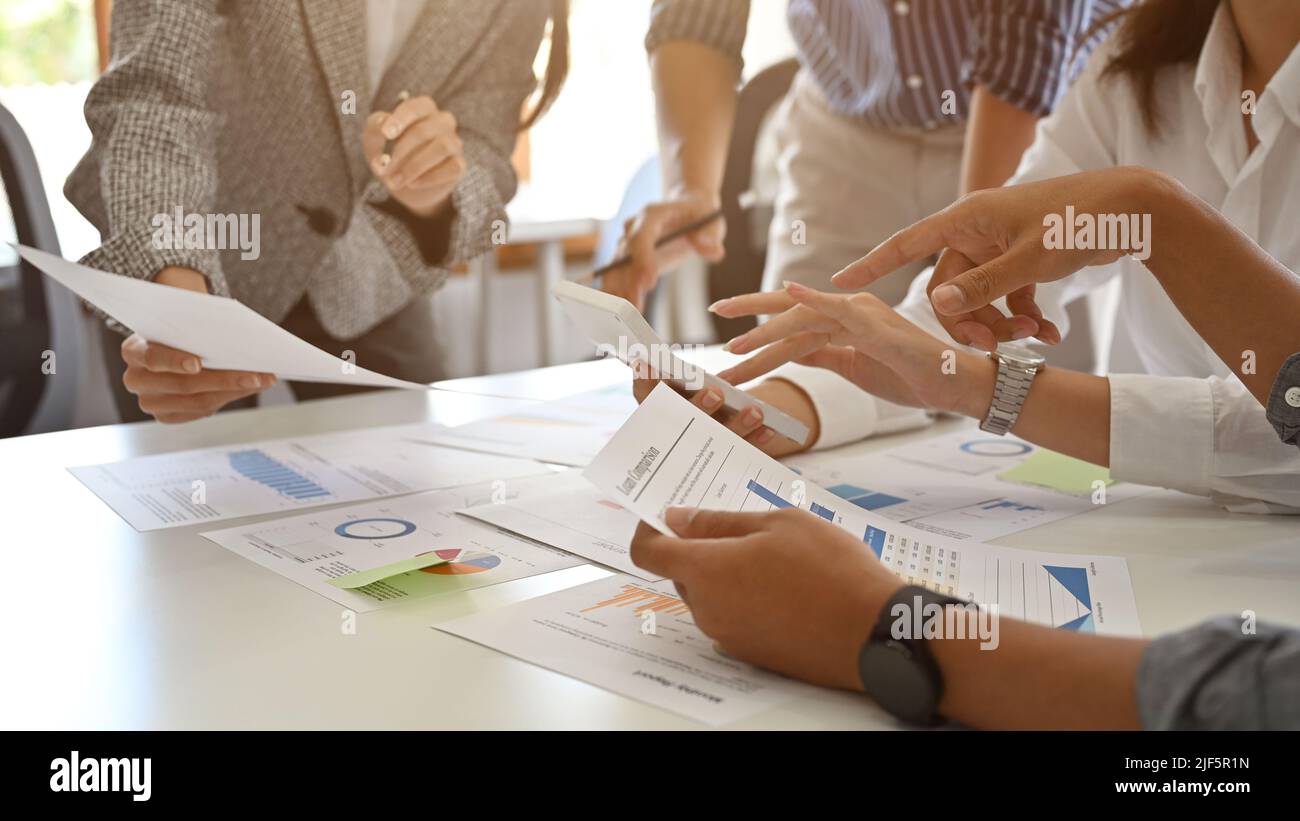 Close-up image, A businesspeople hands on the report over the meeting table. A businesspeople working together, having a business meeting. Stock Photo