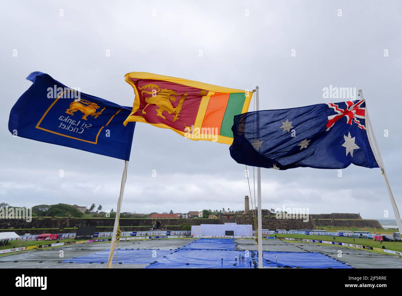 Galle, Sri Lanka. 30th June 2022. The flags of (L-R) Sri Lanka Cricket, Sri Lanka and Australia flutter in the breeze above the ground during the 2nd day of the 1st test cricket match between Sri Lanka vs Australia at the Galle International Cricket Stadium in Galle on 30th June, 2022. Viraj Kothalwala/Alamy Live News Stock Photo