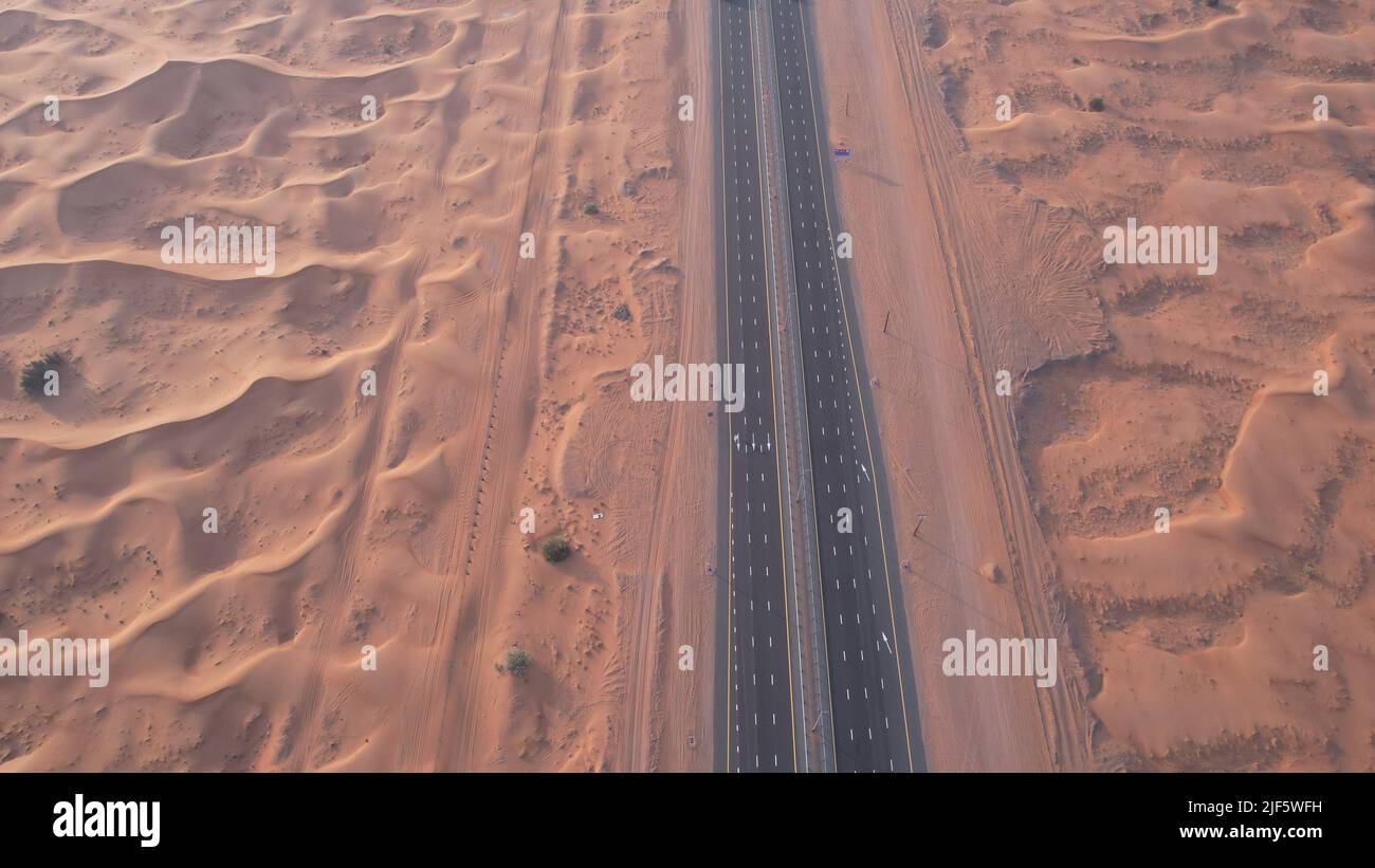 aerial view of sand dunes and a highway in a Sharjah desert, UAE ...