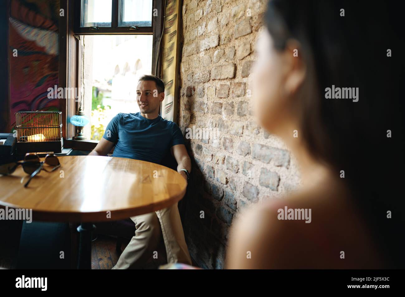 Thoughtful handsome man sitting in cafe and looking away Stock Photo