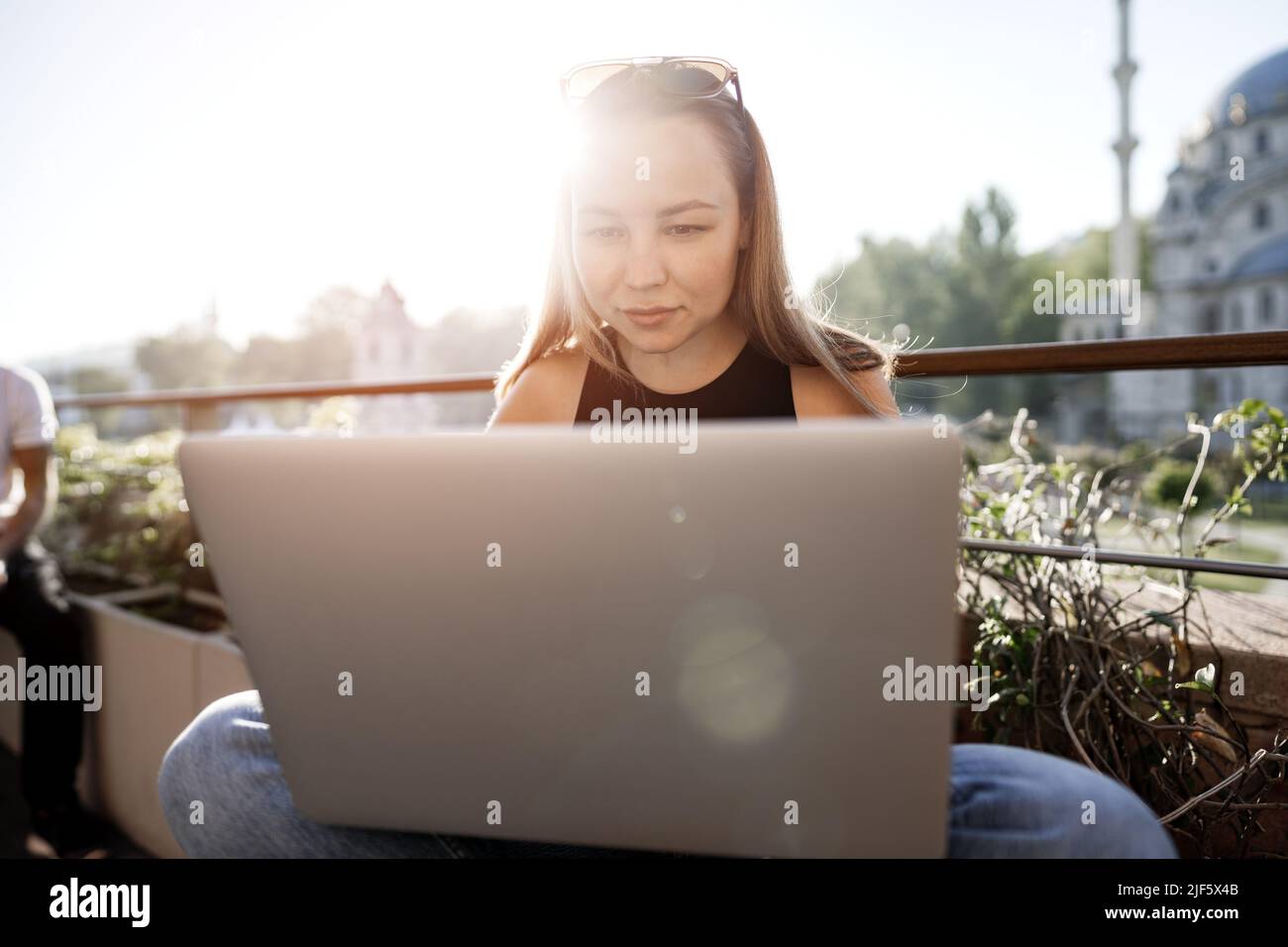 Young blonde businesswoman using laptop working at the terrace in Istanbul Stock Photo