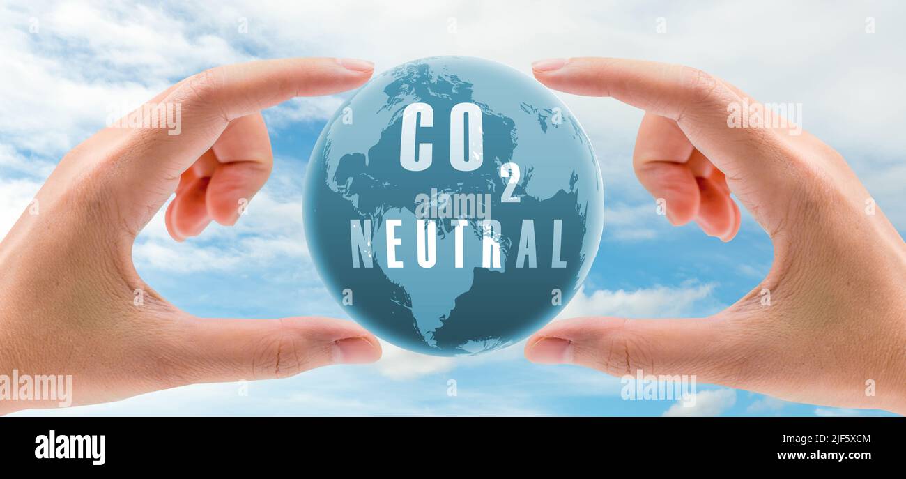 Carbon neutral concept. Hand holding CO2 neutral in globe map on blue