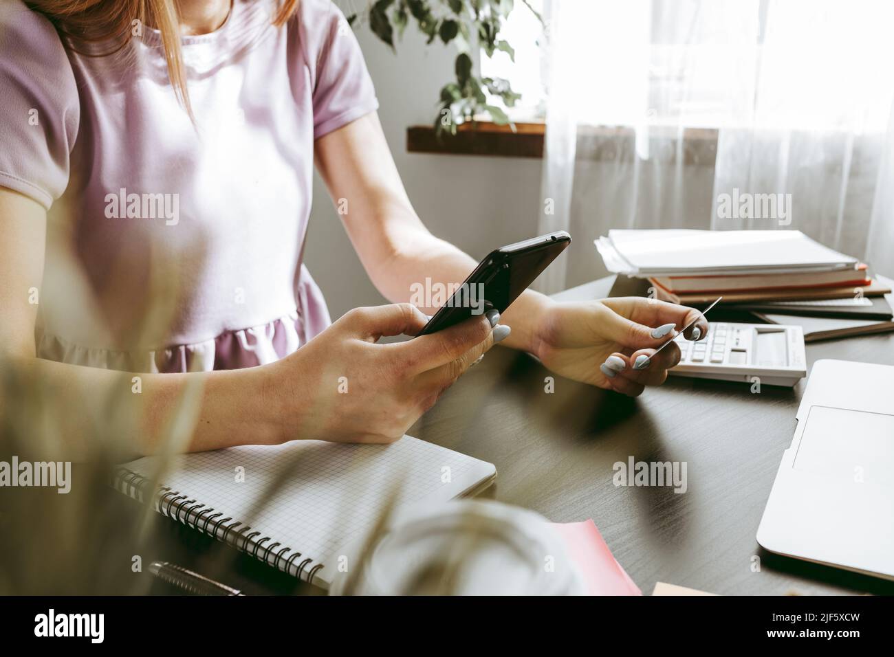 Businesswoman using mobile phone in modern office Stock Photo