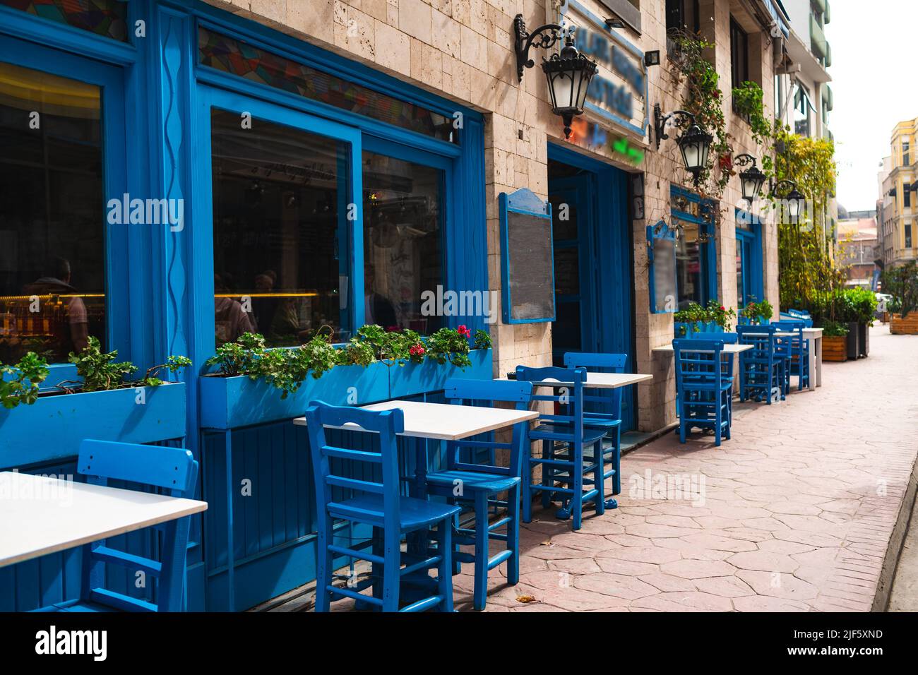 Street cafe in blue tones, empty tables in Istanbul Stock Photo