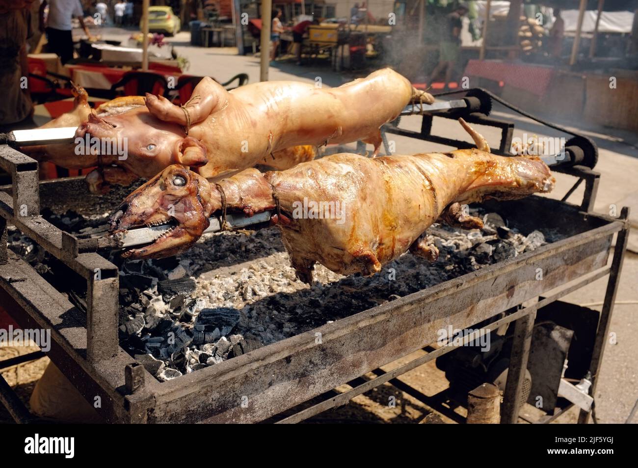 pork and sheep whole roasting on spit at the Guca Trumpet Festival in Serbia Stock Photo