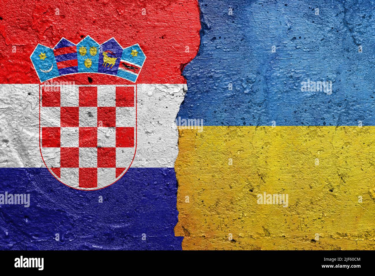Croatia and Ukraine - Cracked concrete wall painted with a Croatian flag on the left and a Ukrainian flag on the right Stock Photo