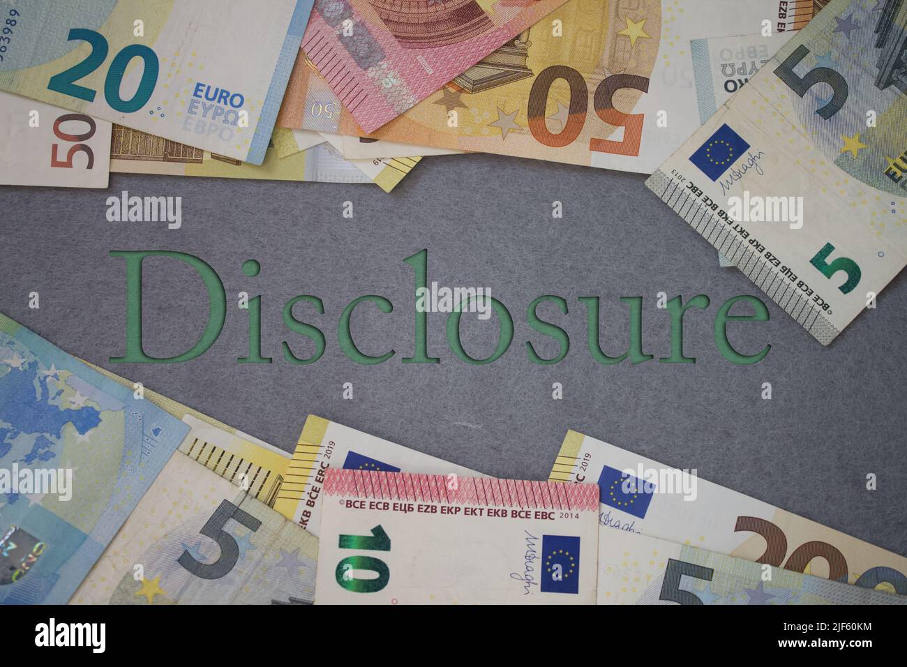 Disclosure word with money. Paper currency background with different banknotes. Stock Photo