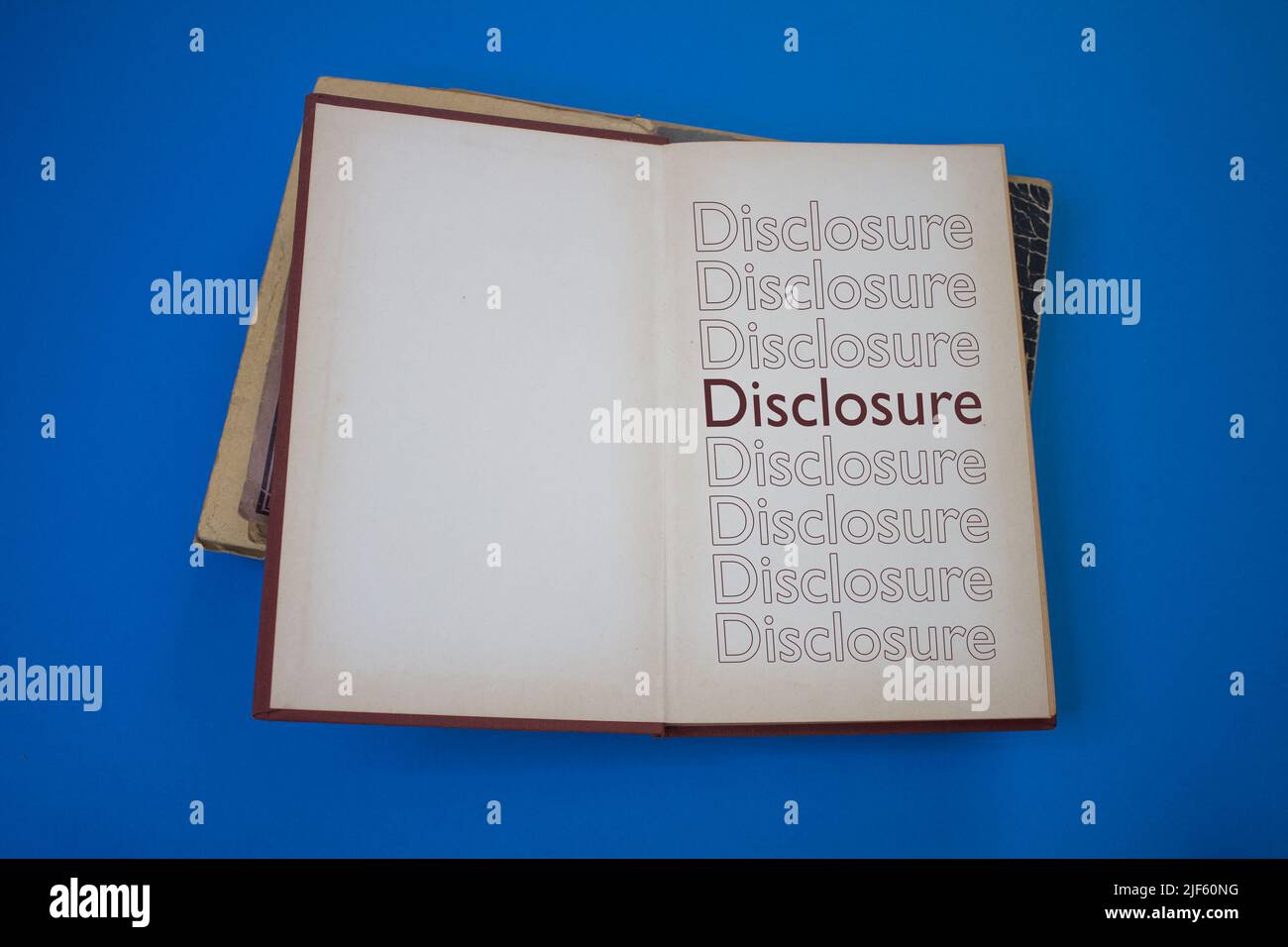 Disclosure word in opened book with vintage, natural patterns old antique paper design. Stock Photo