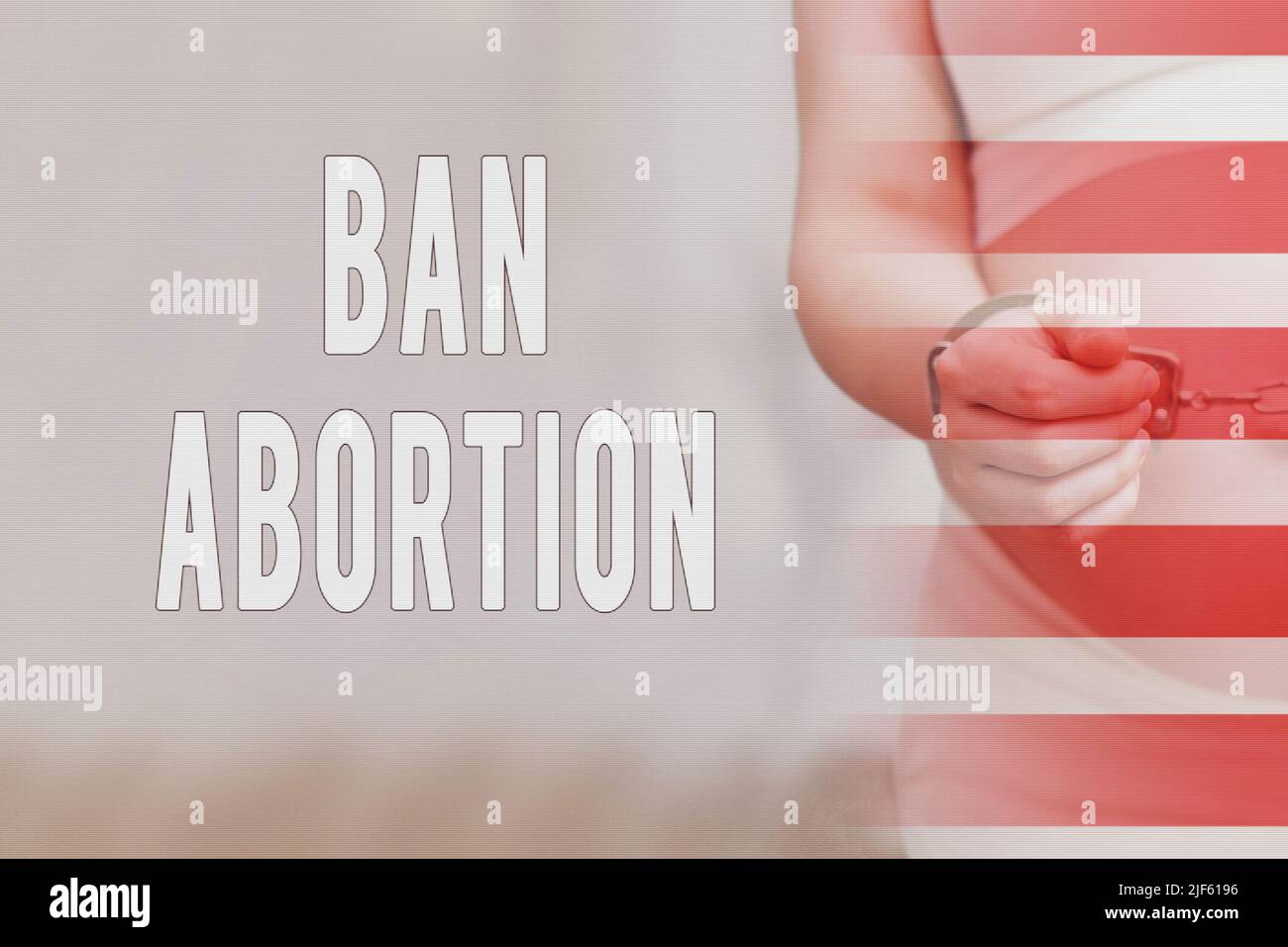 Text about the ban on abortions and chained hands of a pregnant woman, home living room Stock Photo