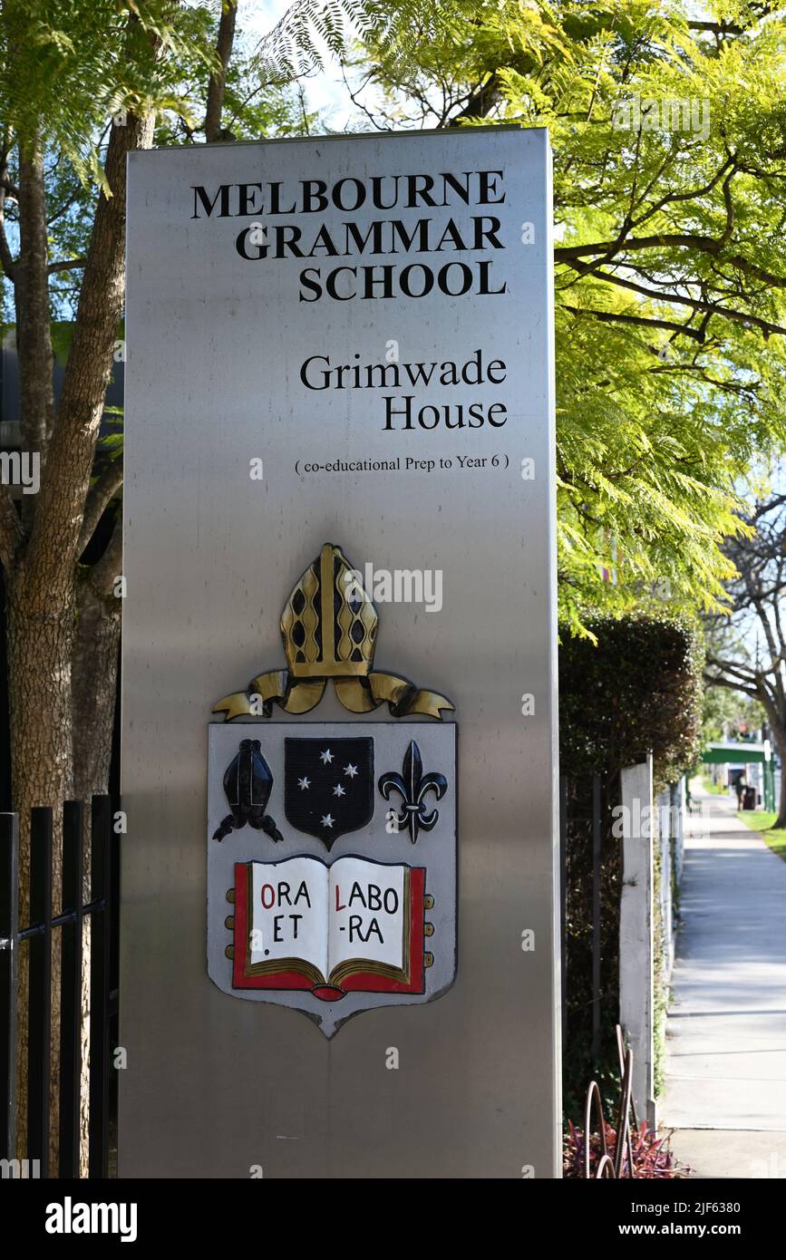 Sign outside entrance to Melbourne Grammar School's Grimwade House, featuring the school emblem Stock Photo