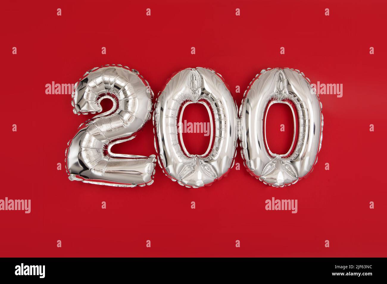 Silver balloon showing number 200 on red background Stock Photo