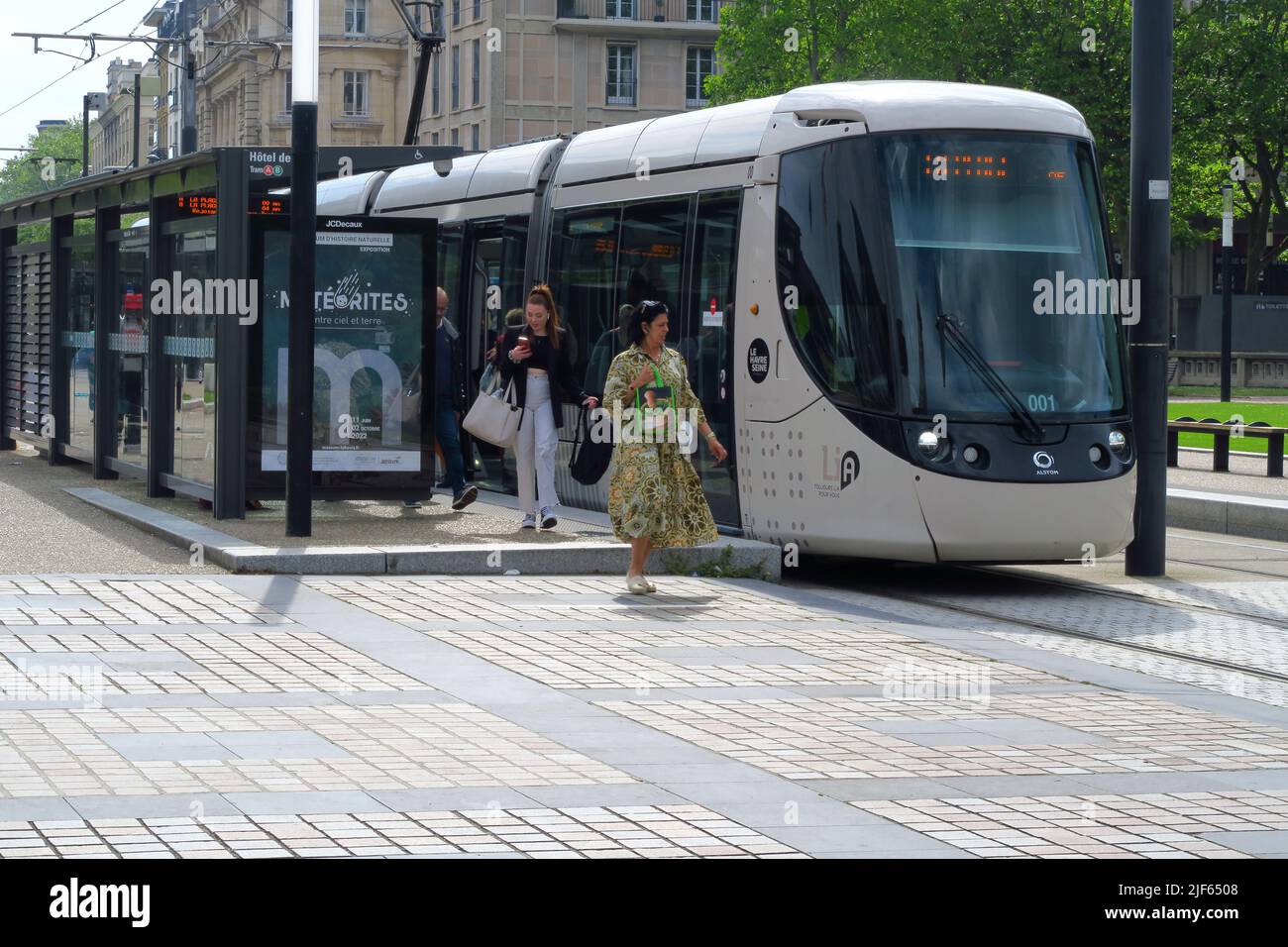 A city tram at a stop outside the Hotel de Ville, City Hall in the French port of Le Havre. Stock Photo