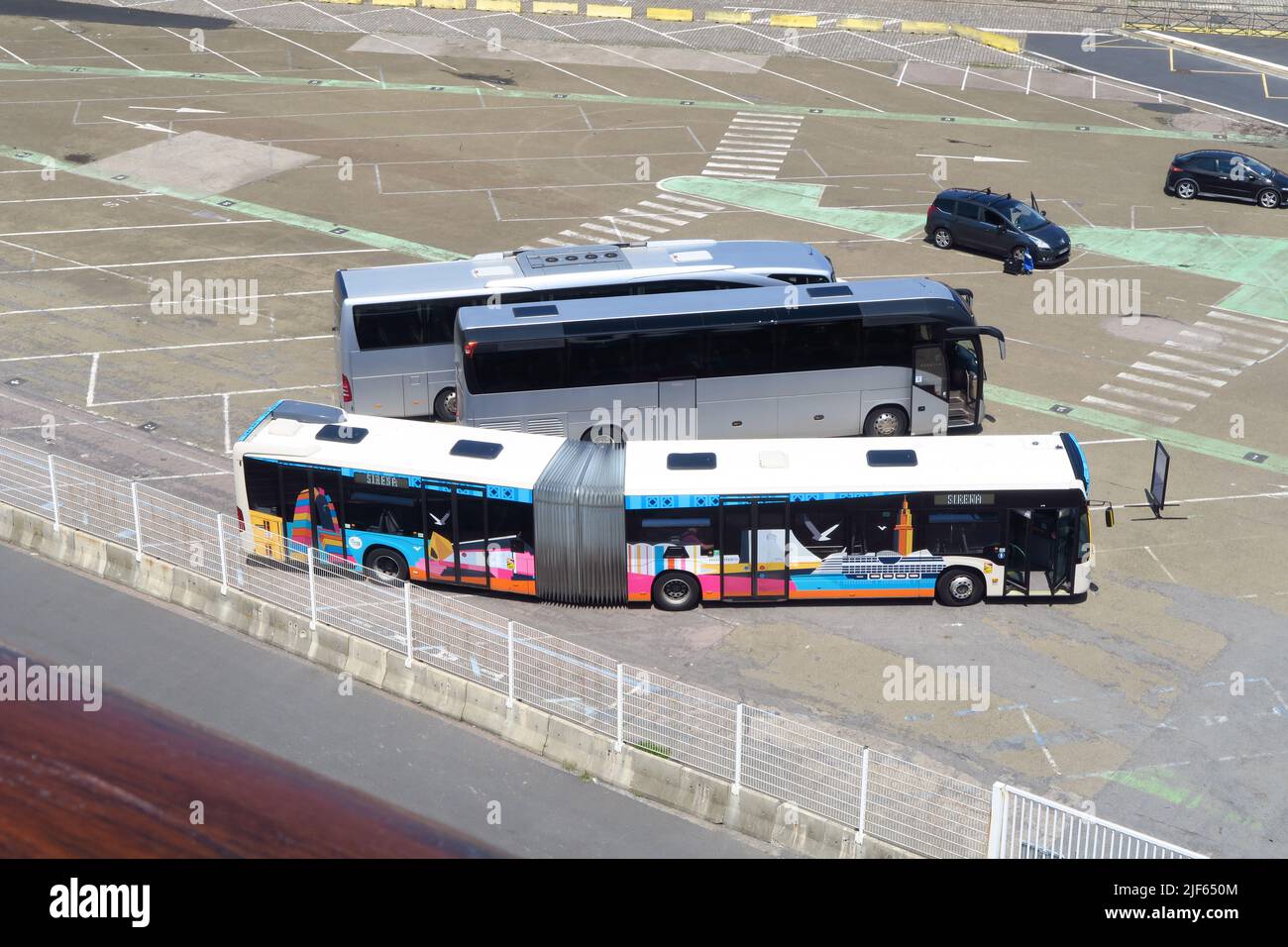 Shuttle buses for cruise ships wait for passengers at the Ocean Cruise Terminal in the French