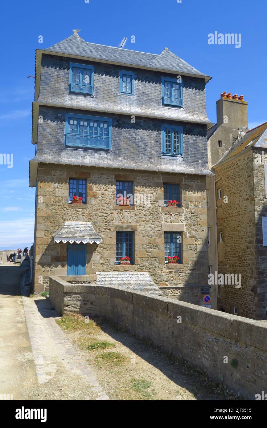 One of the many multiple storeyed buildings that stand along the city walls of the french port of St Malo Stock Photo