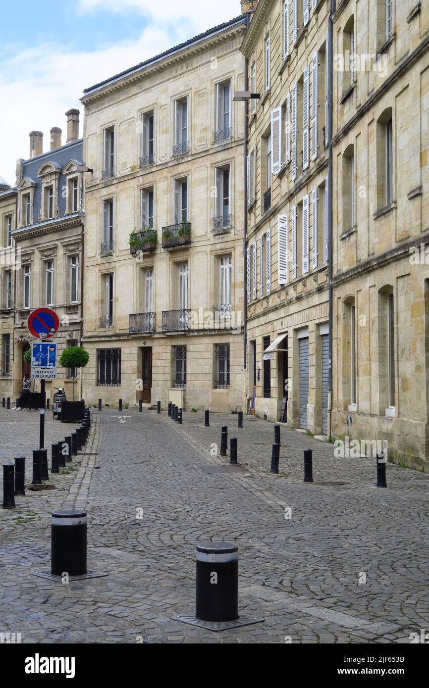 Rue Mably, a cobbled street in ther French city of Bordeaux has some interesting buildings with shuttered windows or Juliet balconies Stock Photo