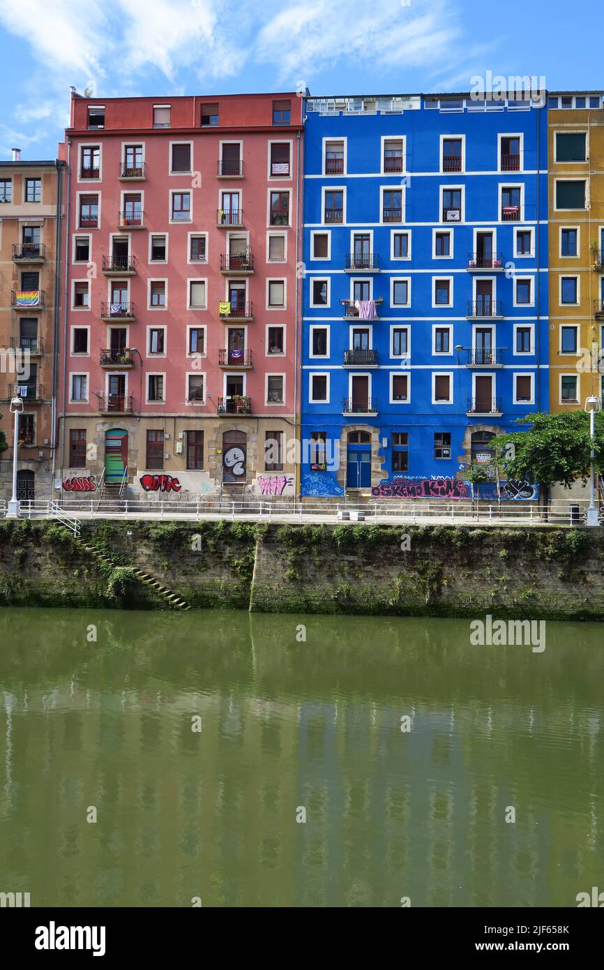 Colourful apartment blocks on the south side of the Rio de Bilbao as seen from La Ribera Market, Bilbao, Spain Stock Photo