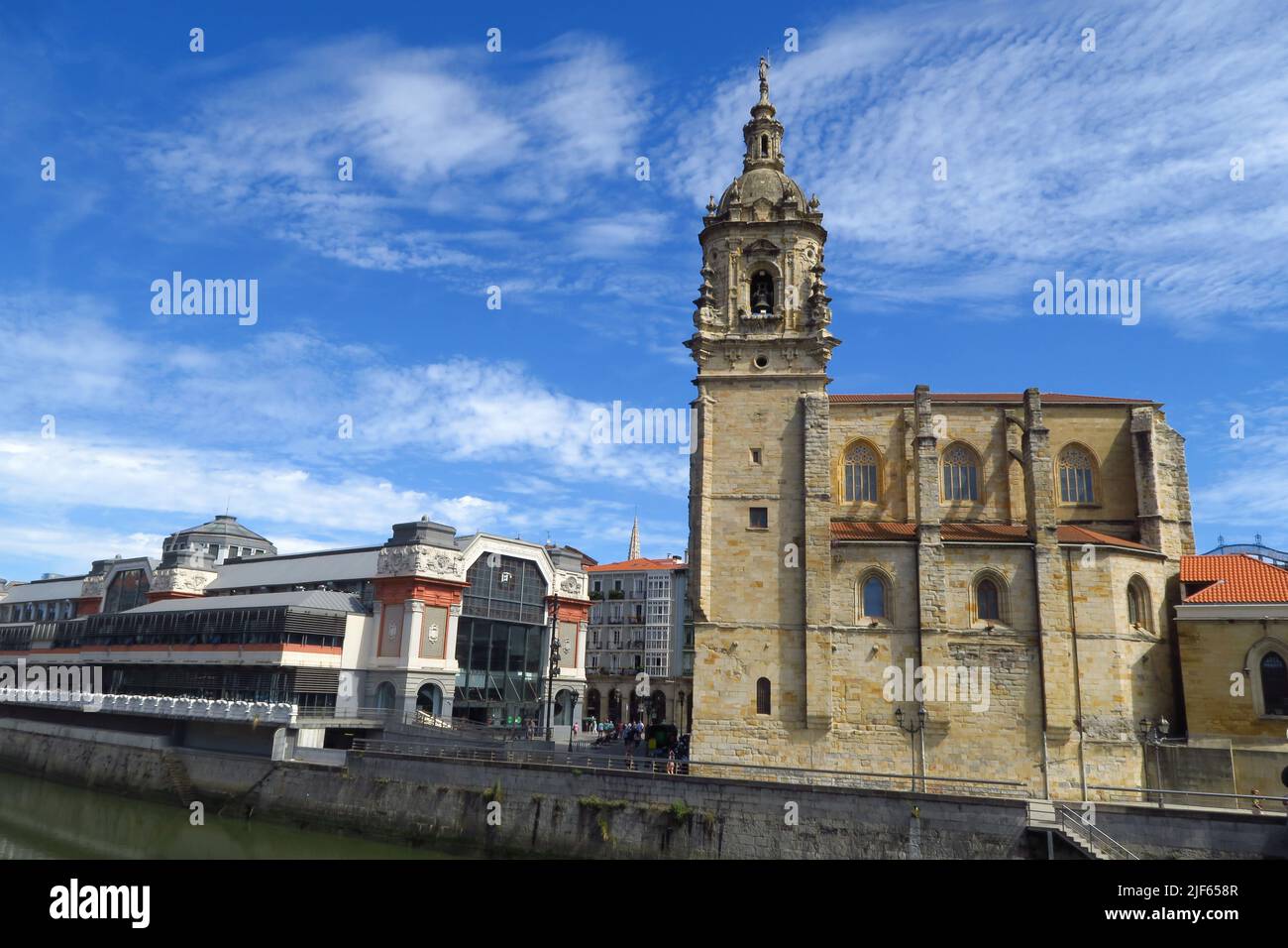 La Ribera Market and St Anthony's Church lie on the north bank of the Rio de Bilboa in Bilbao, Spain Stock Photo