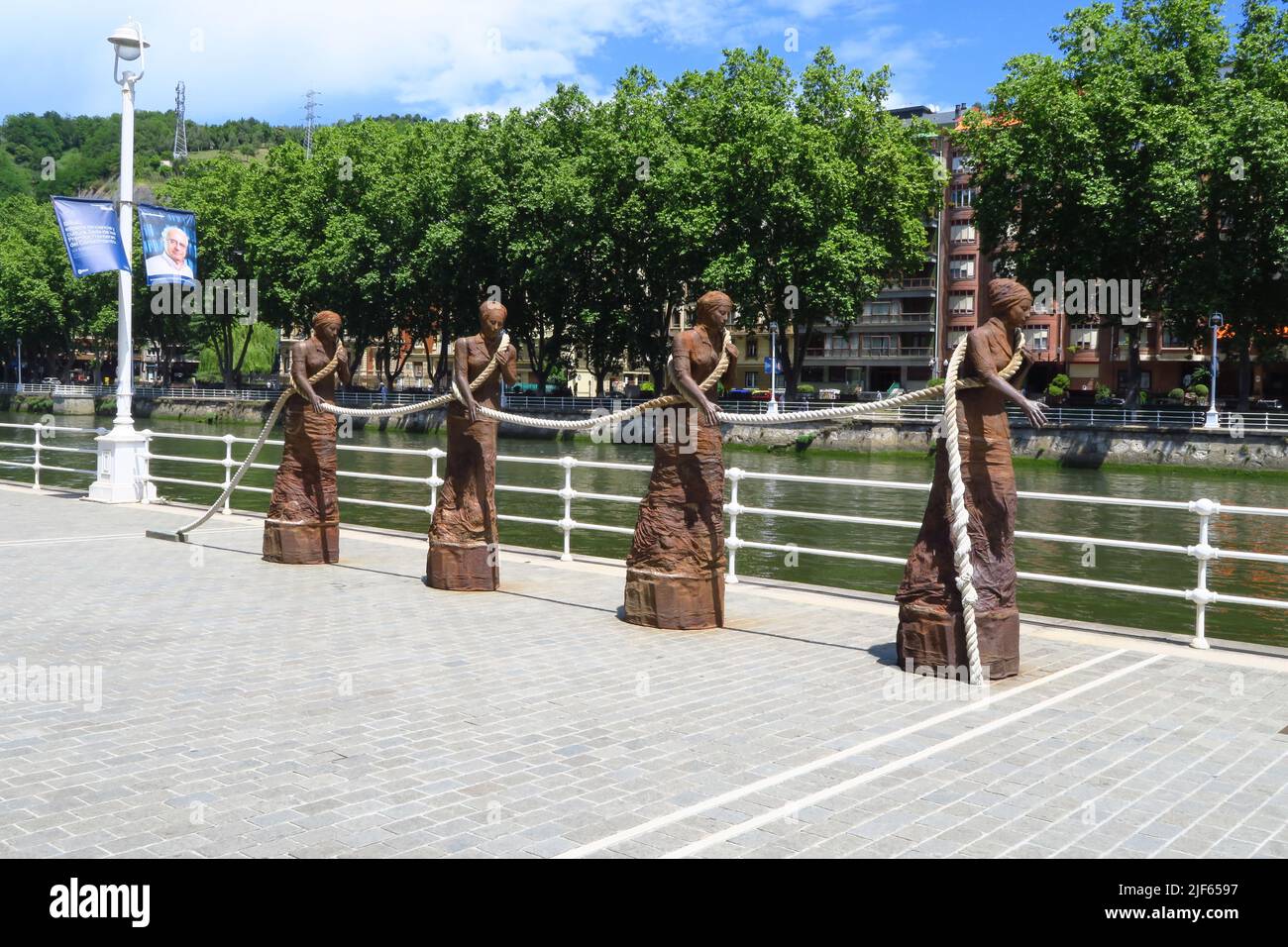 Las Sirgueras, a sculpture by Dora Salazar, Paseo Uribitarte in Bilbao, Spain. It pays tribute to the sirgueras, the rope girls, women who towed boats Stock Photo